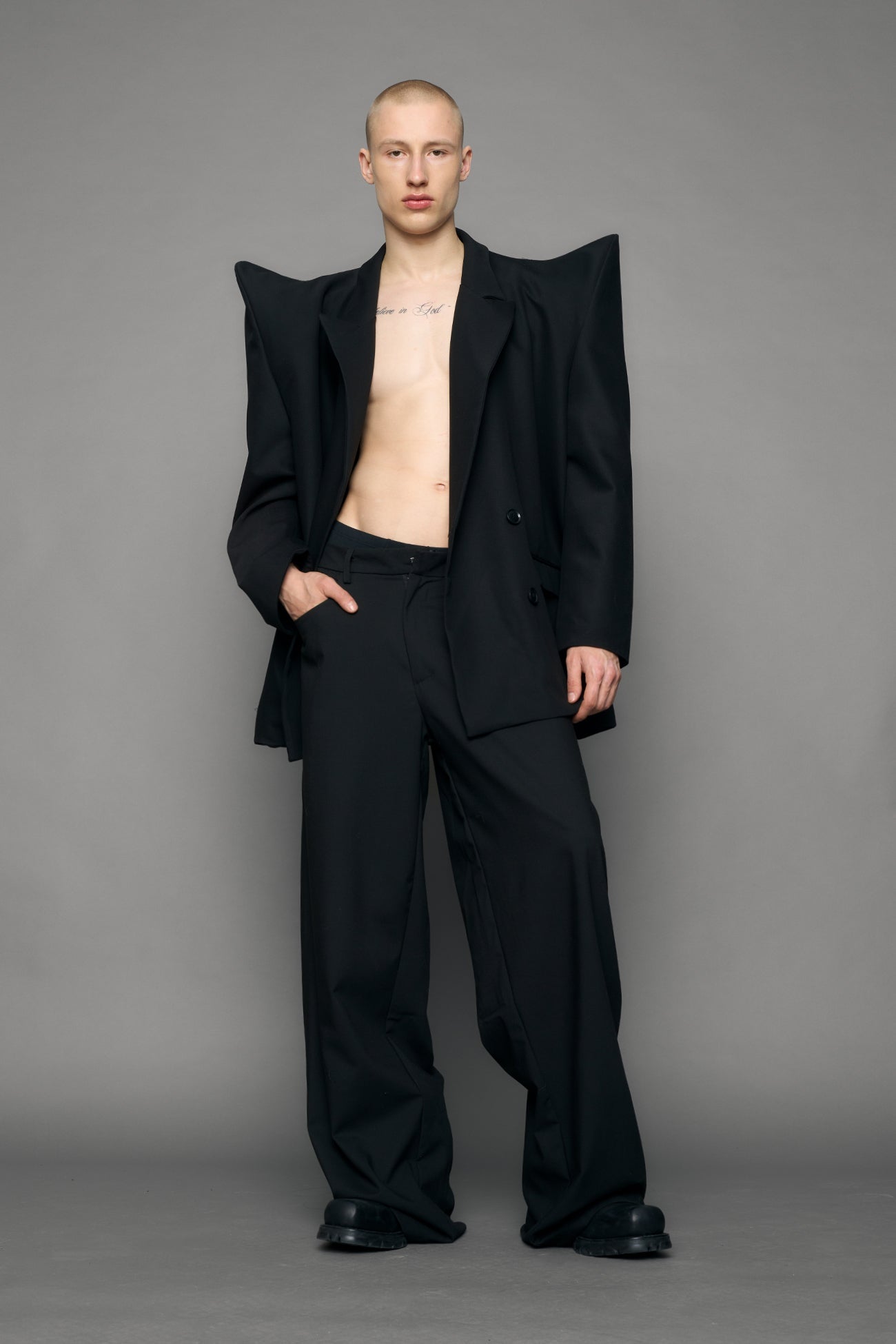 model wearing black blazer with sharp shoulder design
