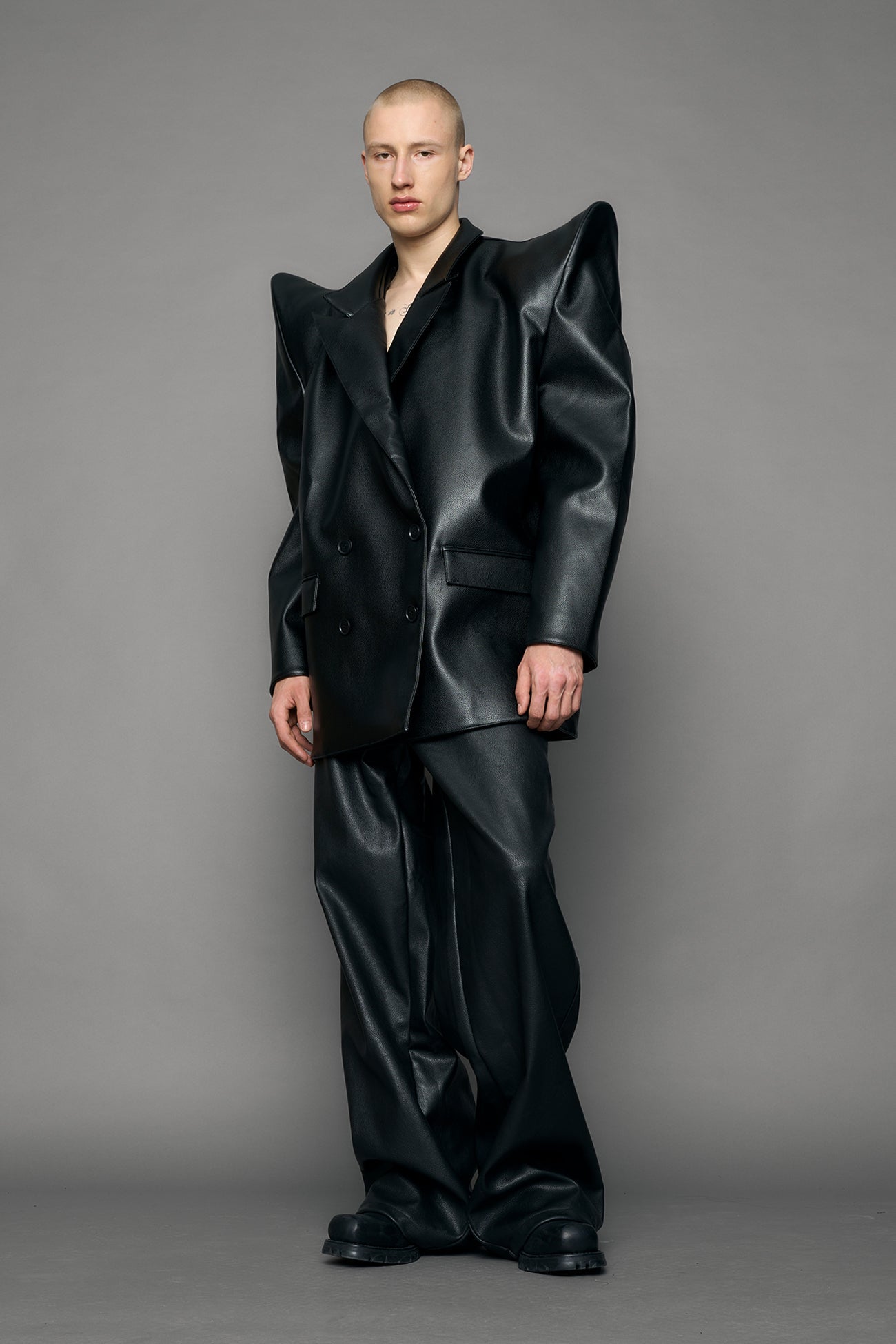 model wearing black pu leather blazer with sharp shoulder design