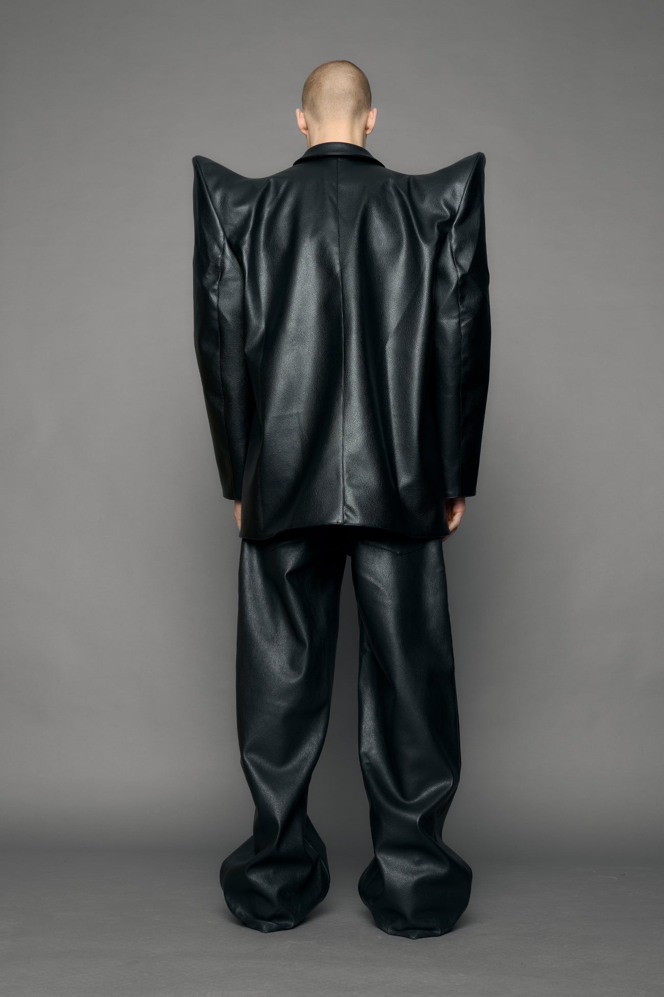 model wearing black pu leather blazer with sharp shoulder design
