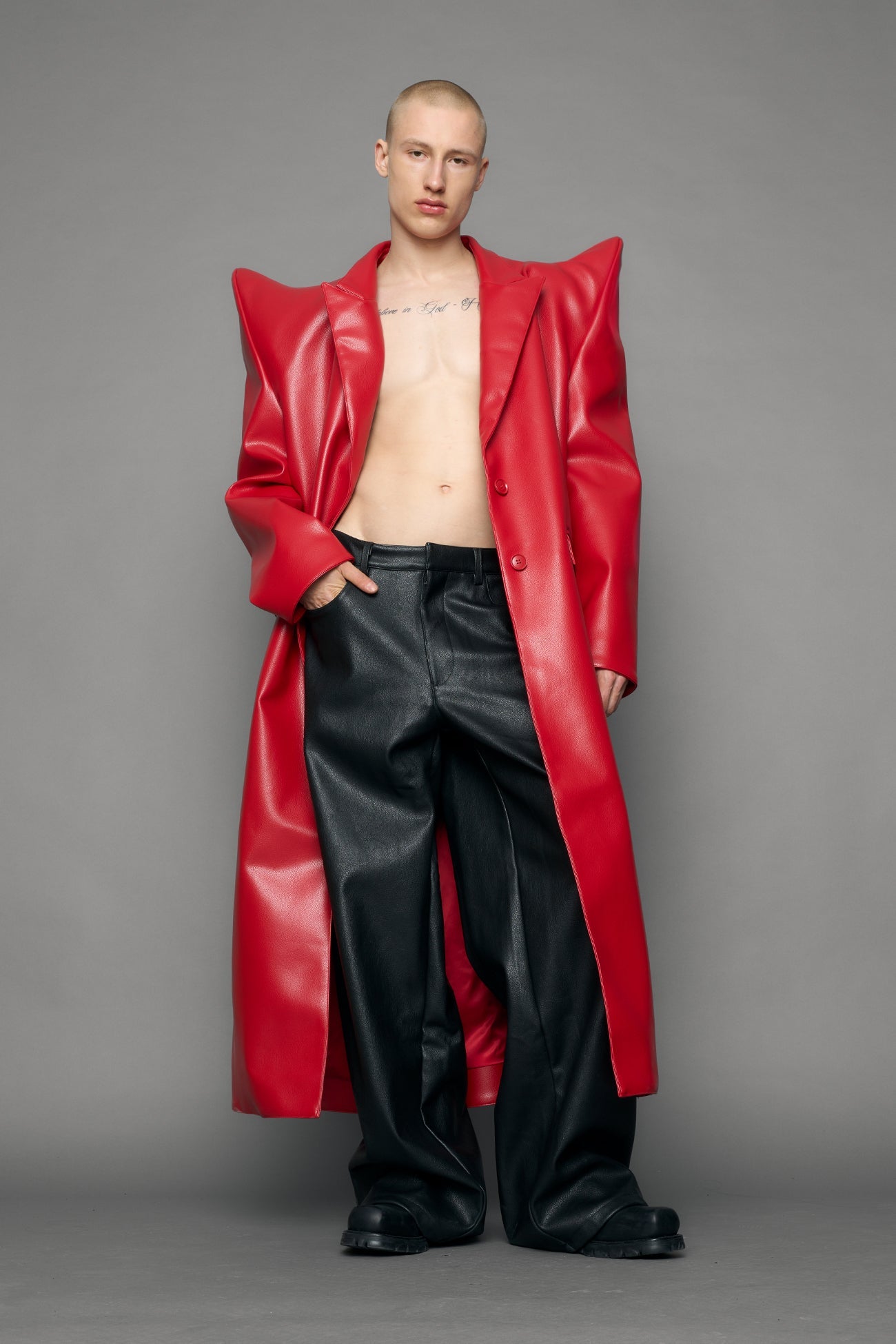 model wearing red pu leather coat with sharp shoulder design