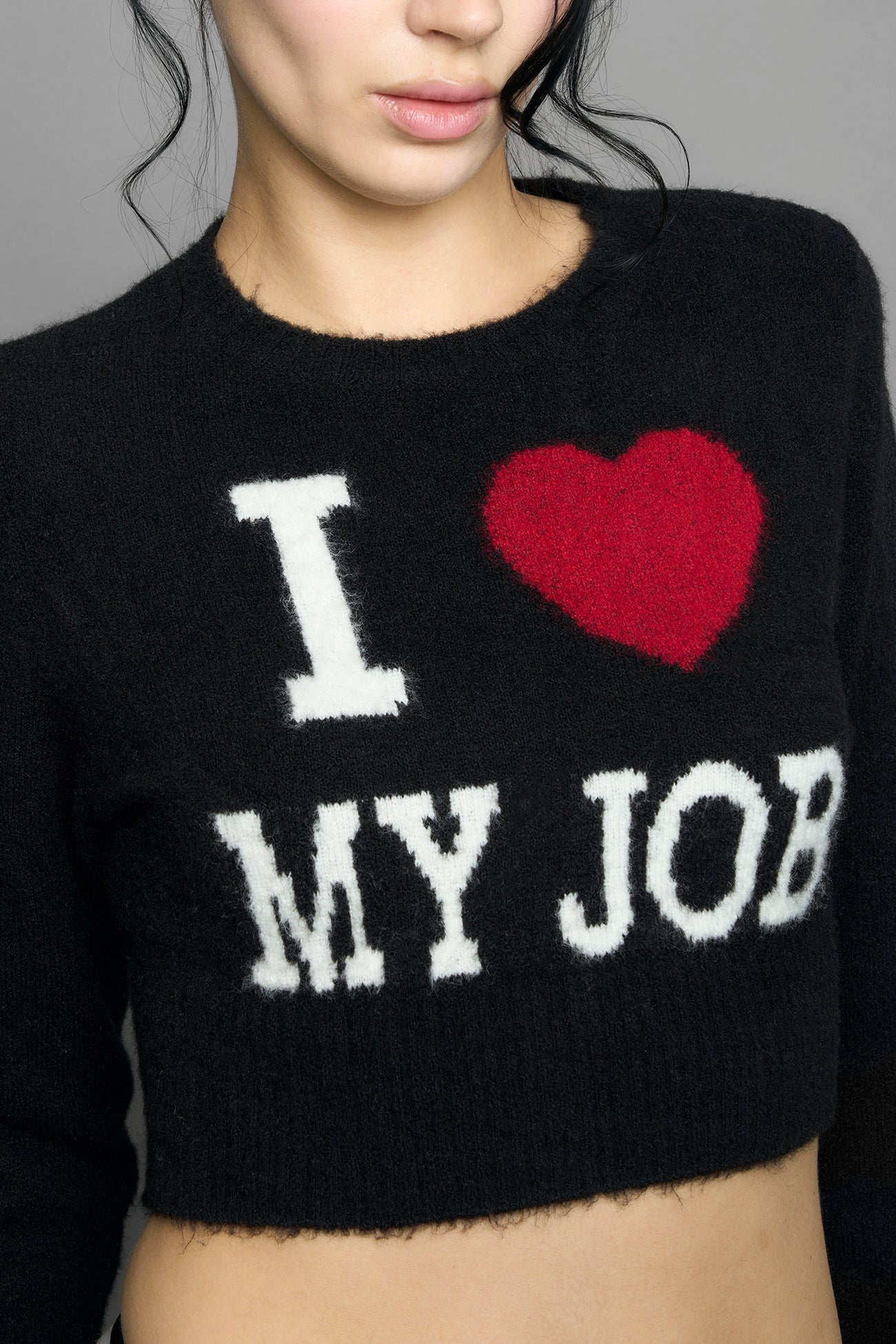 model wearing intarsia knit wool sweater cropped length black