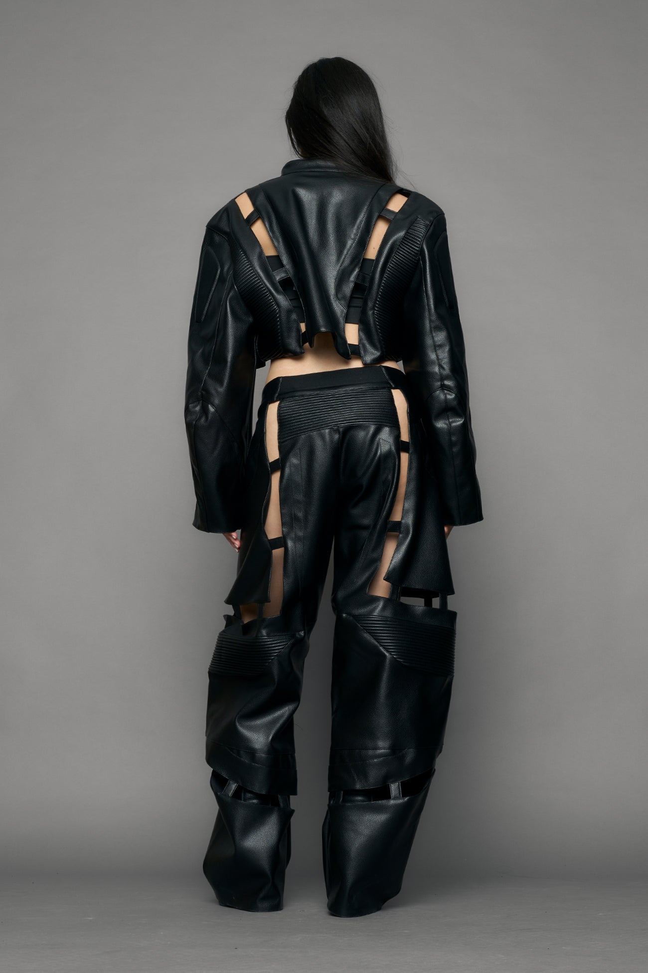 model wearing black moto pu leather jacket with cut out design