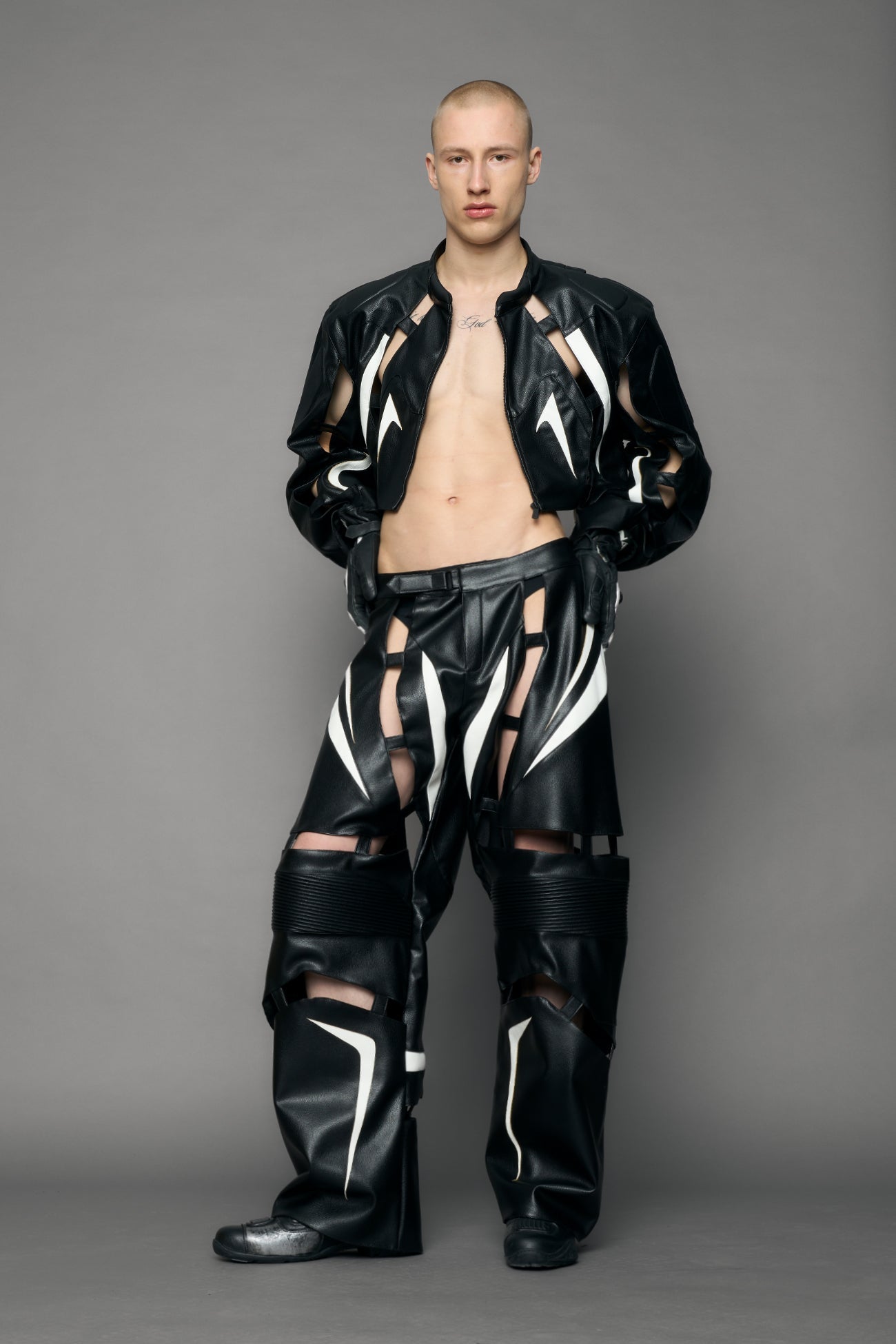 model wearing black and white moto pu leather jacket with cut out design