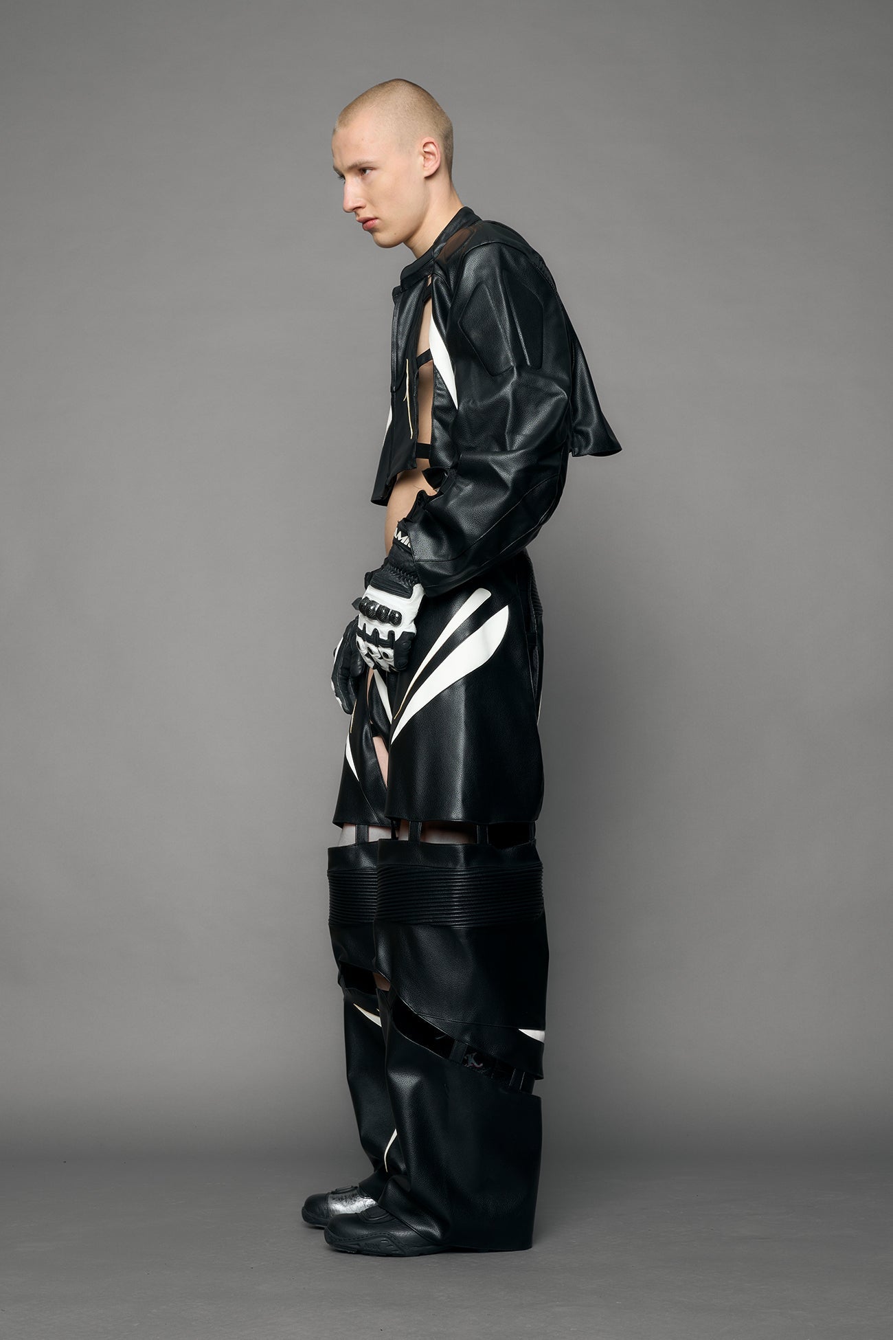 model wearing black and white moto pu leather jacket with cut out design
