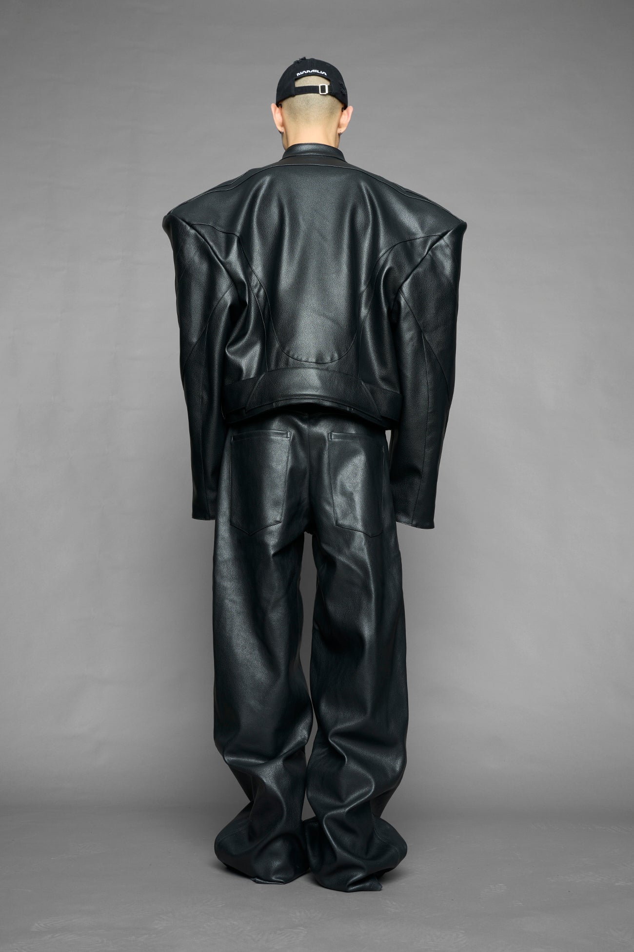 black power shoulder moto jacket with extreme sculpted shoulders and integrated boning construction worn by models studio ecommerce image
