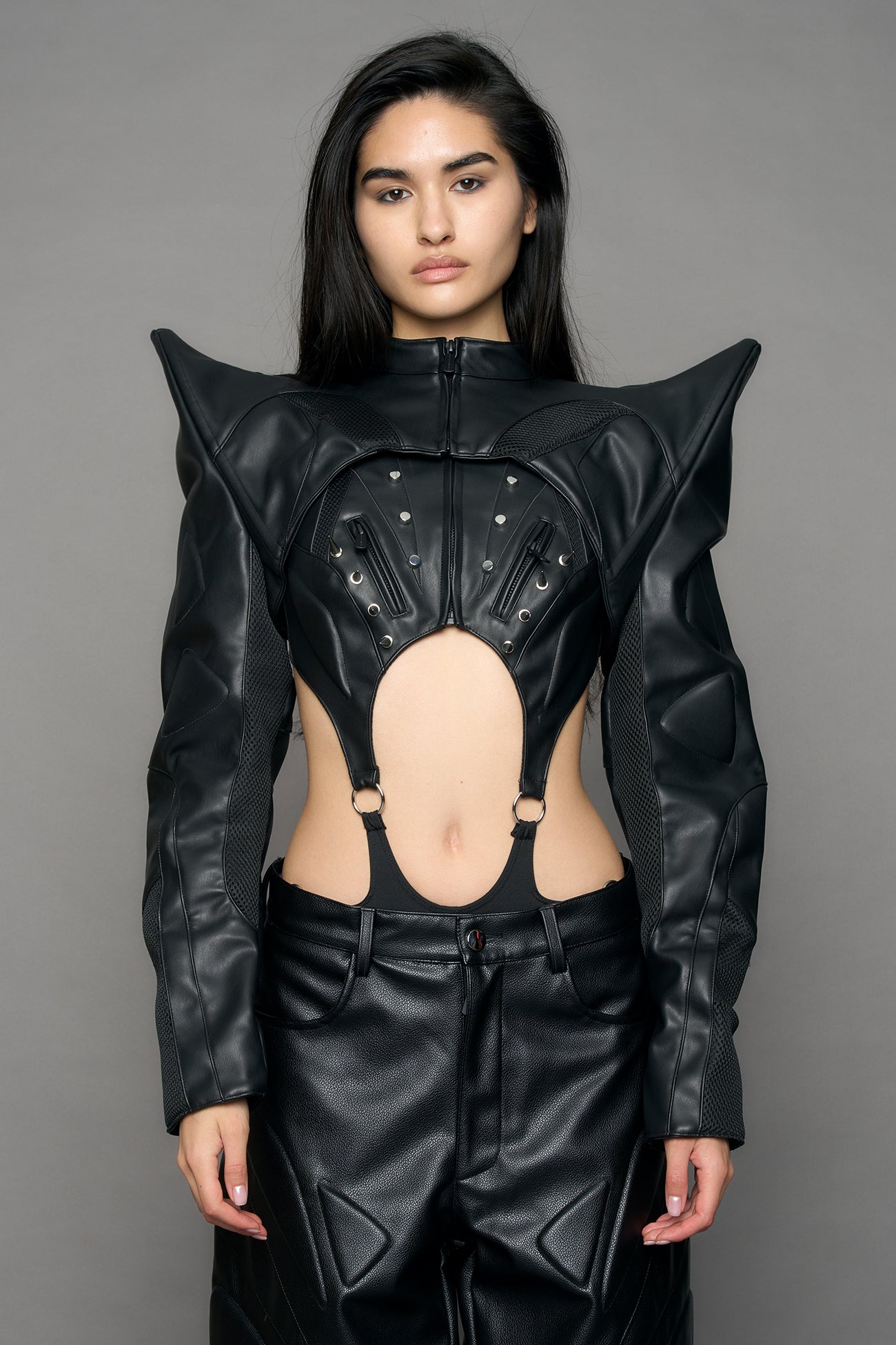Model wearing a black leather choker jacket with cut-out design