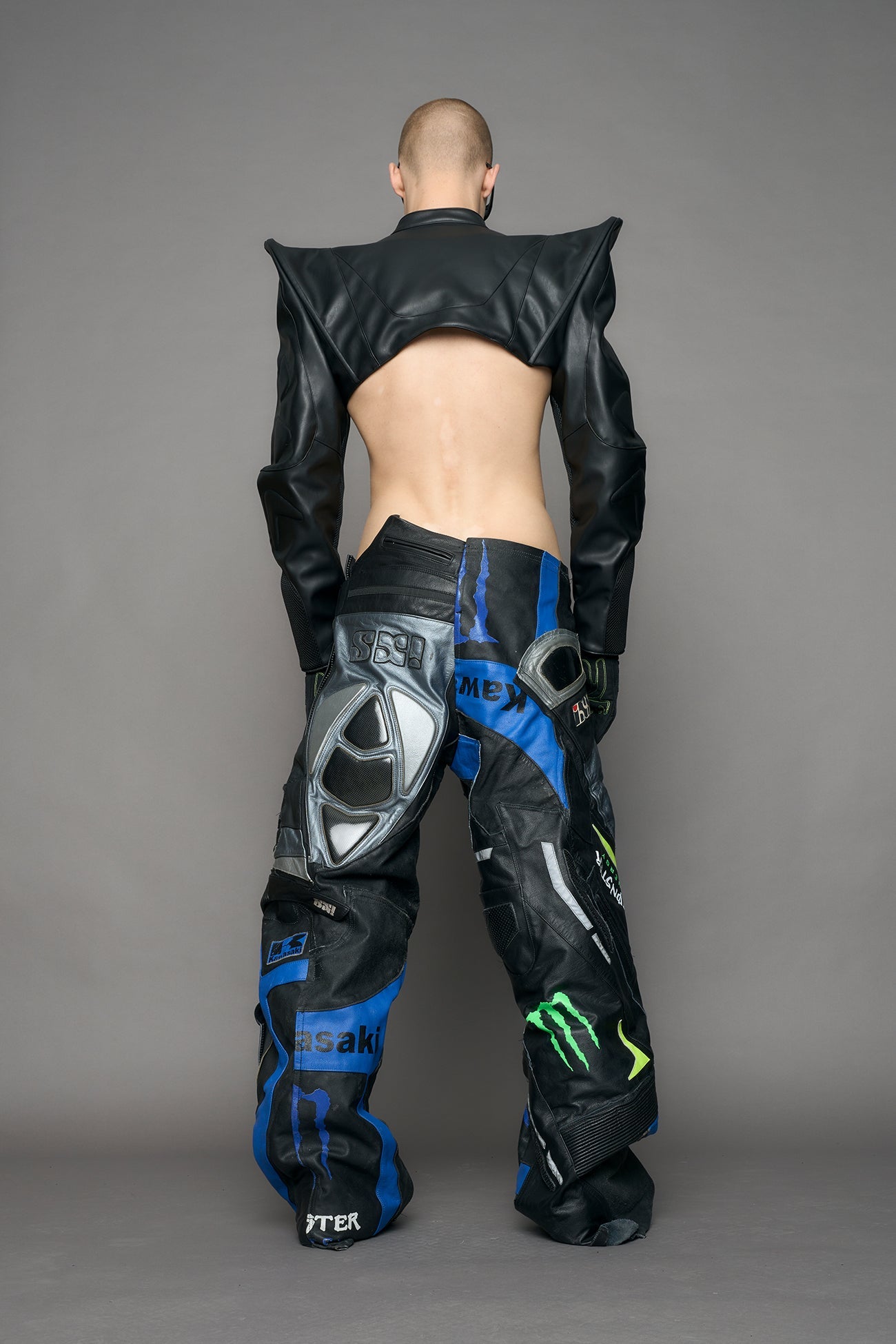 Model wearing a black leather choker jacket with cut-out design