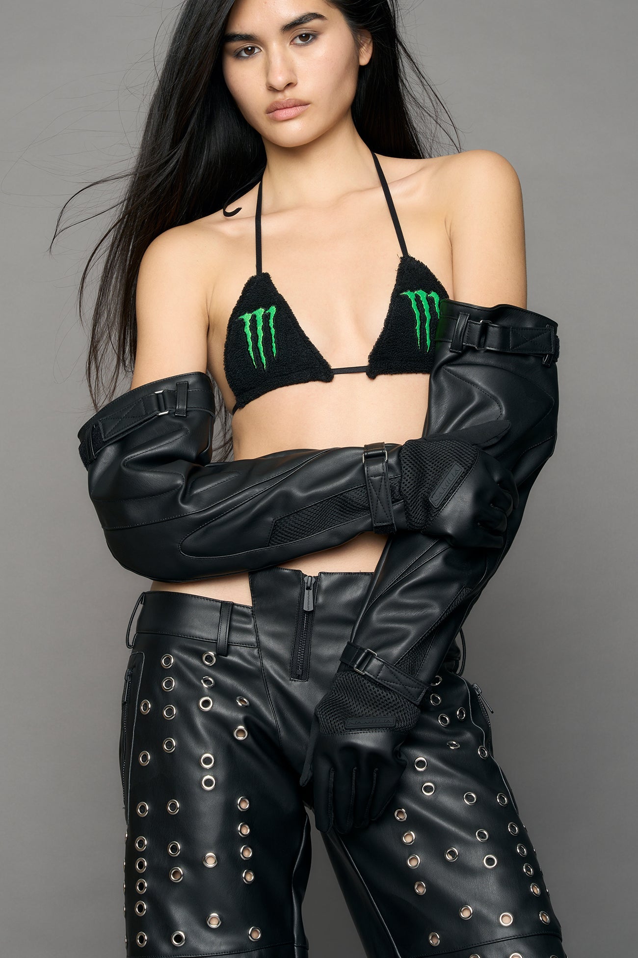 model wearing black pu leather gloves with moto design