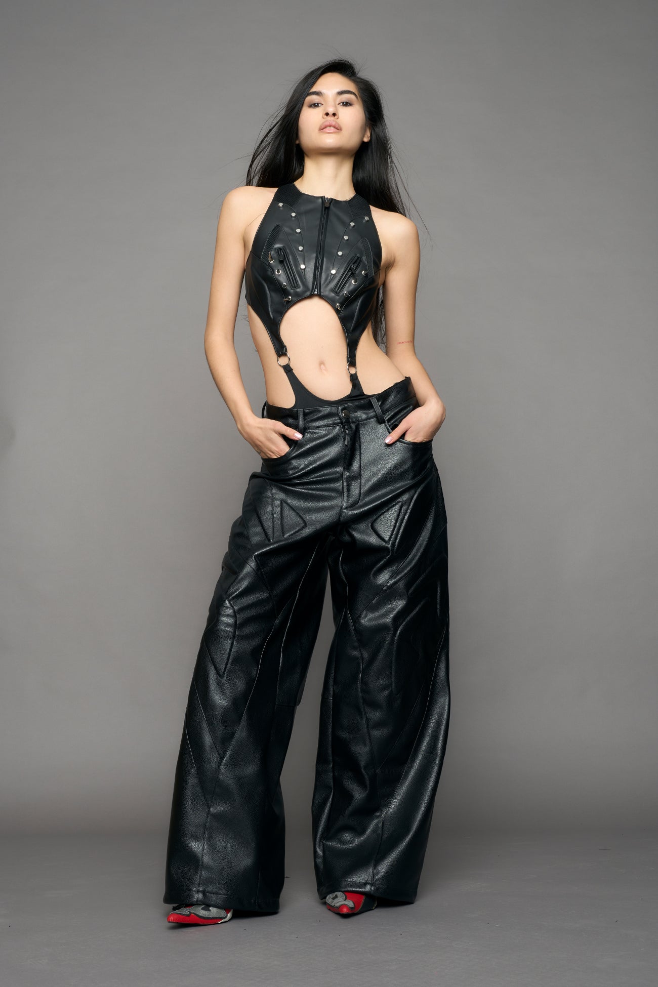 model wearing black oversize pu leather pants with moto style highlights