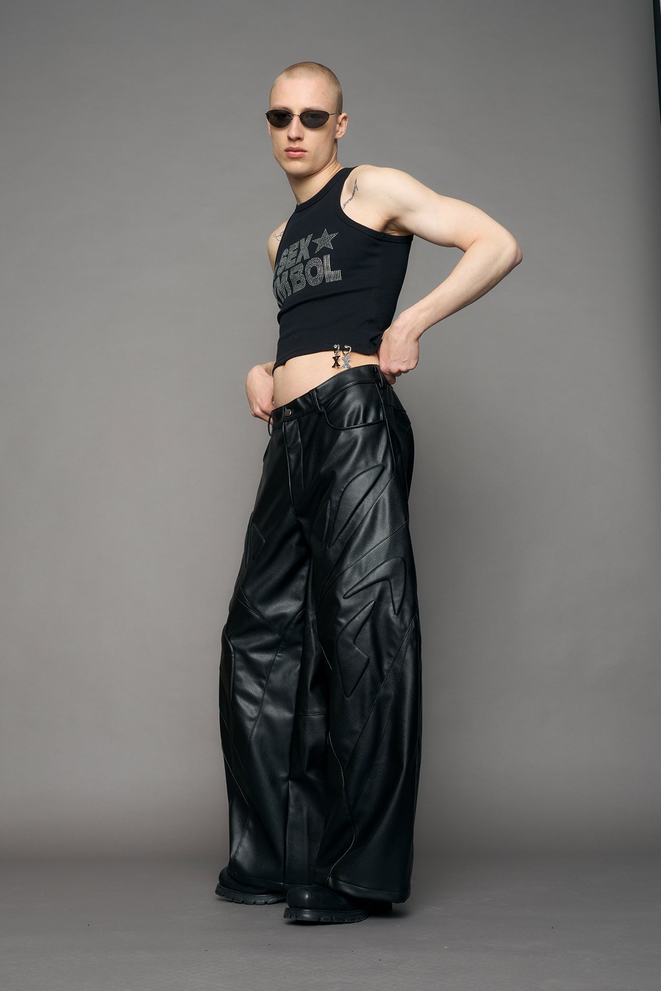 model wearing black oversize pu leather pants with moto style highlights