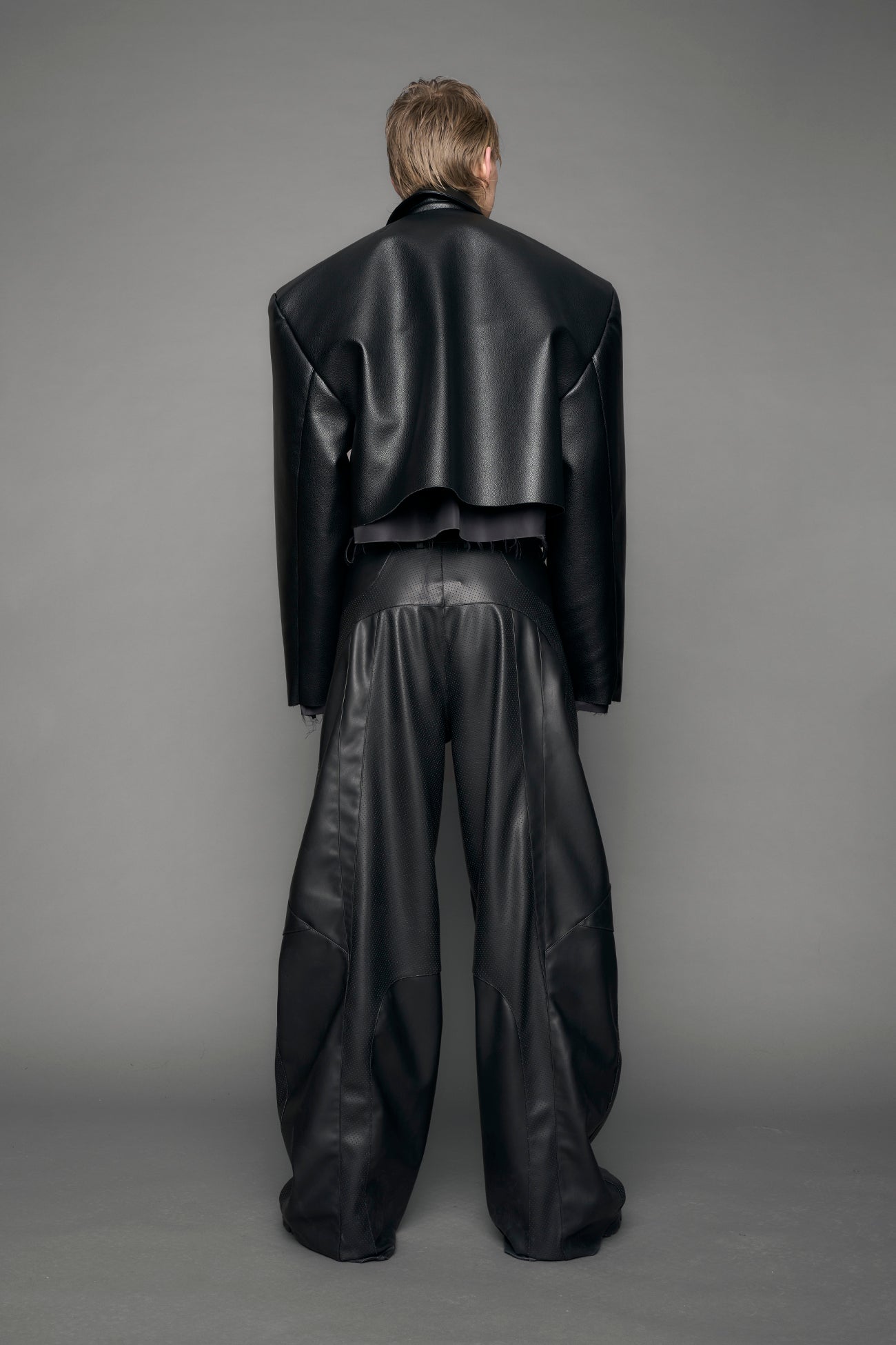 model wearing black vegan leather blazer cropped