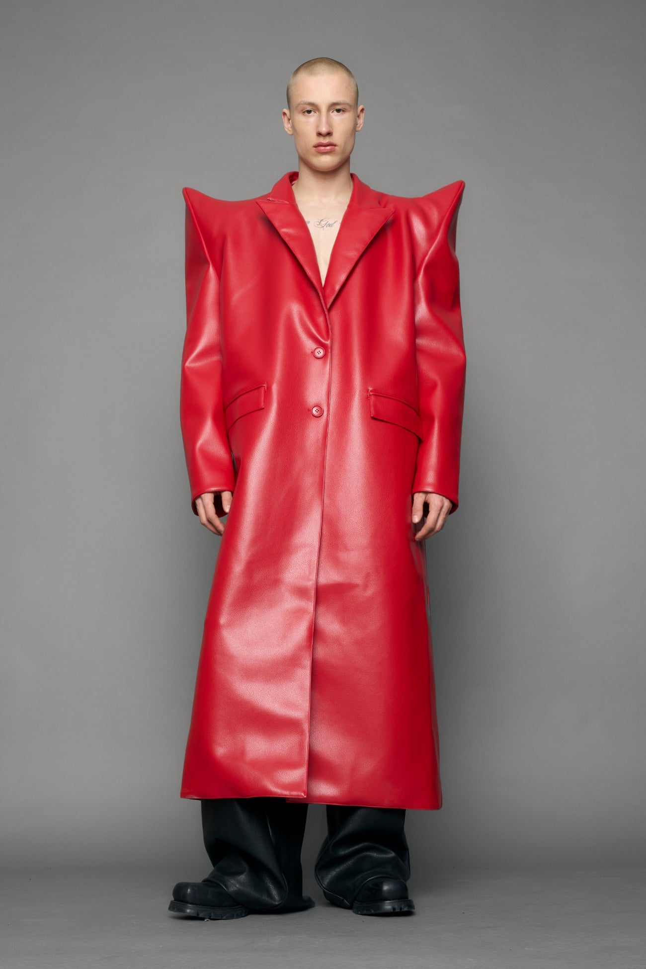 model wearing red pu leather coat with sharp shoulder design