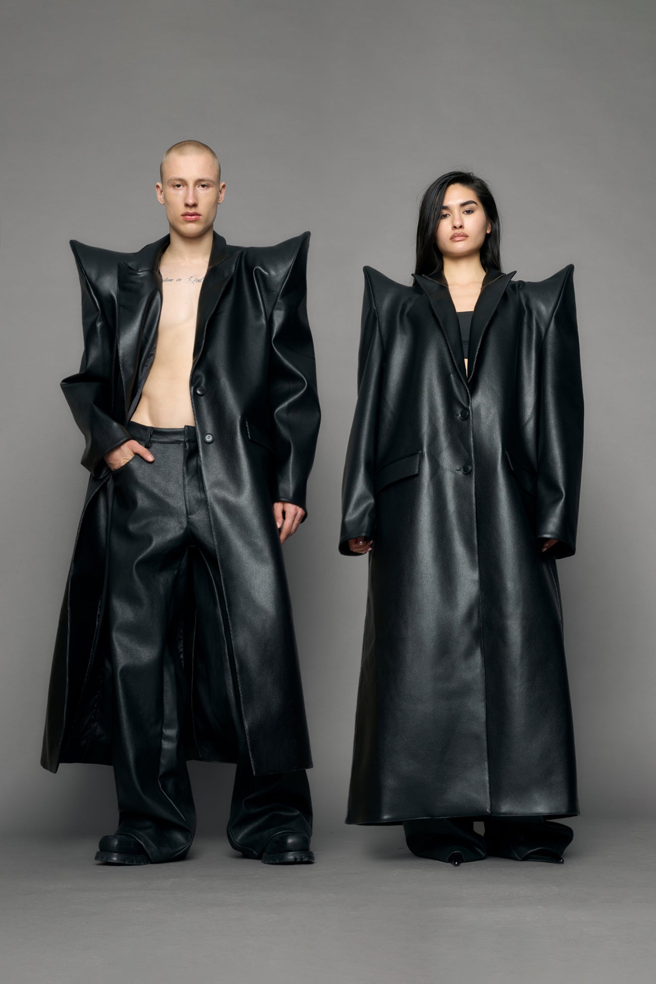 model wearing black pu leather coat with sharp shoulder design