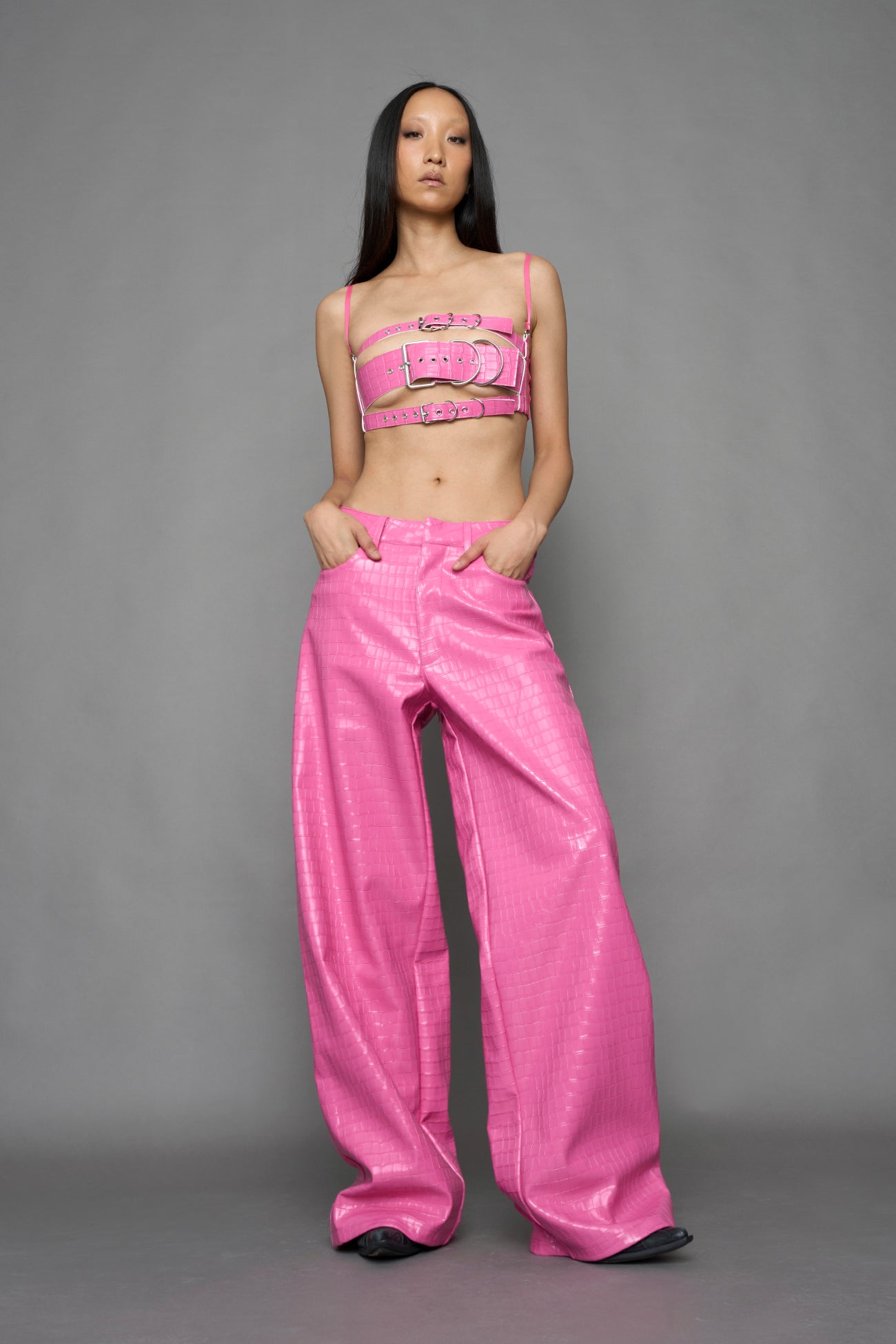 model wearing pink vegan leather croc baggy pants