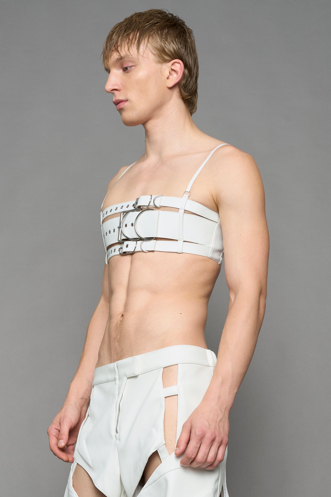 model wearing white vegan leather belt top with buckle details