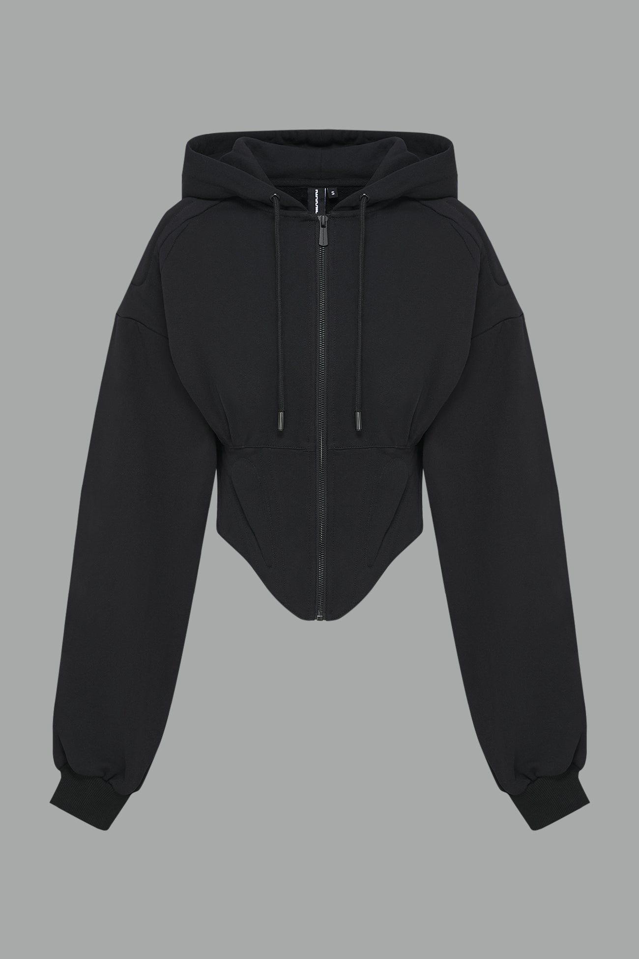 model in a black cropped hoodie featuring structured corset-style paneling embroidered across the chest in tonal black