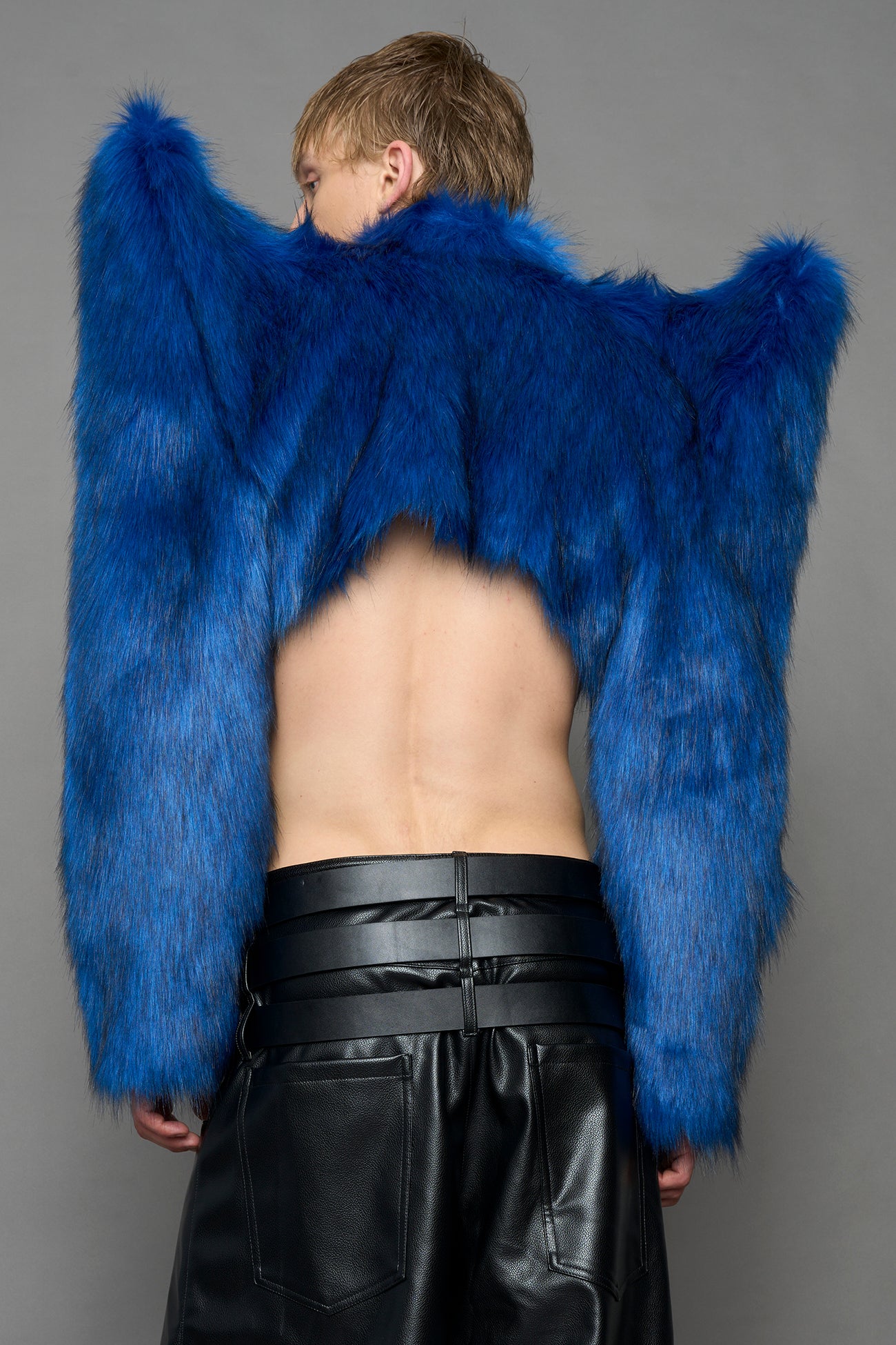 model wearing blue faux fur bolero jacket