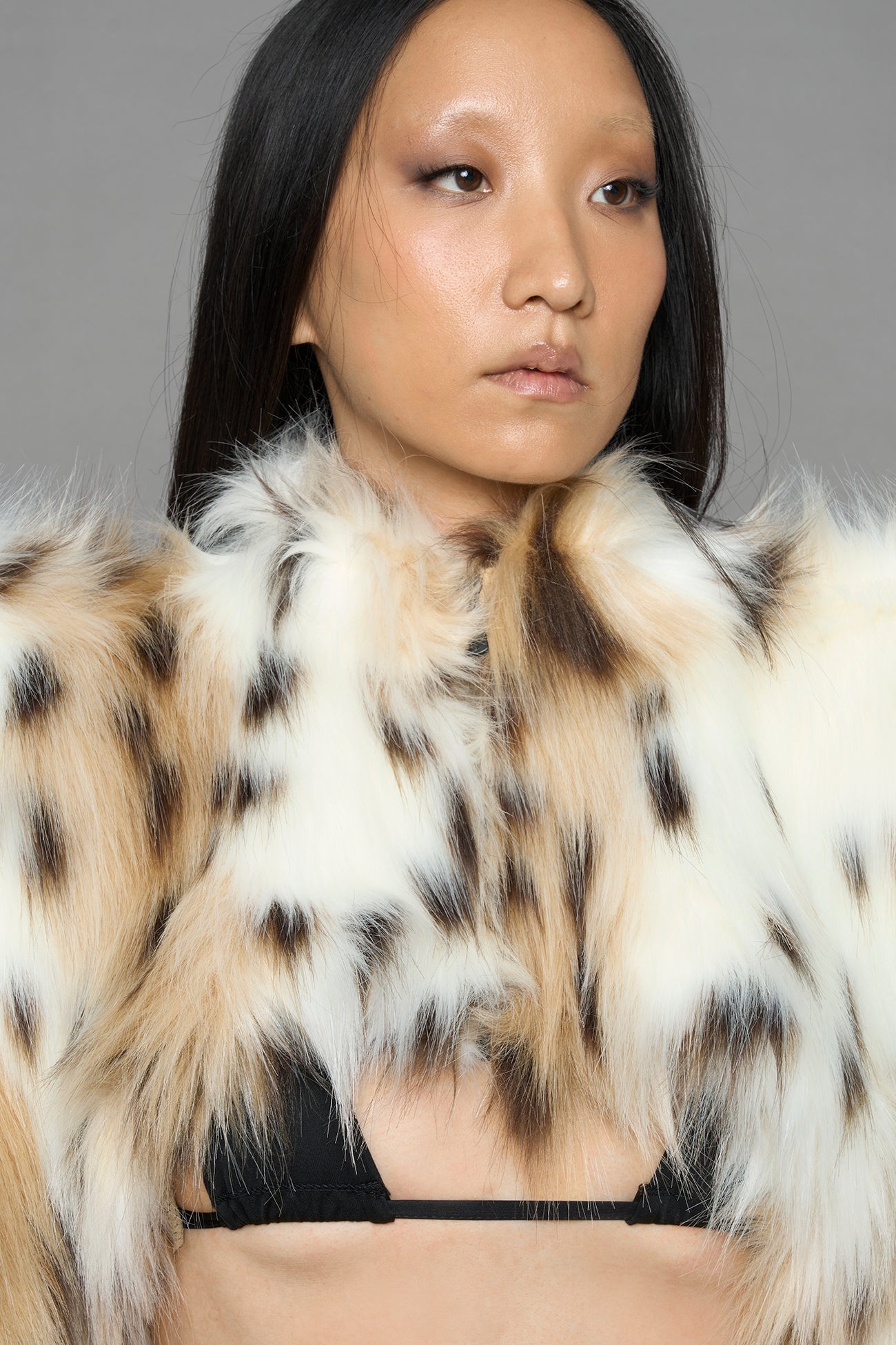 model wearing beige faux fur bolero jacket