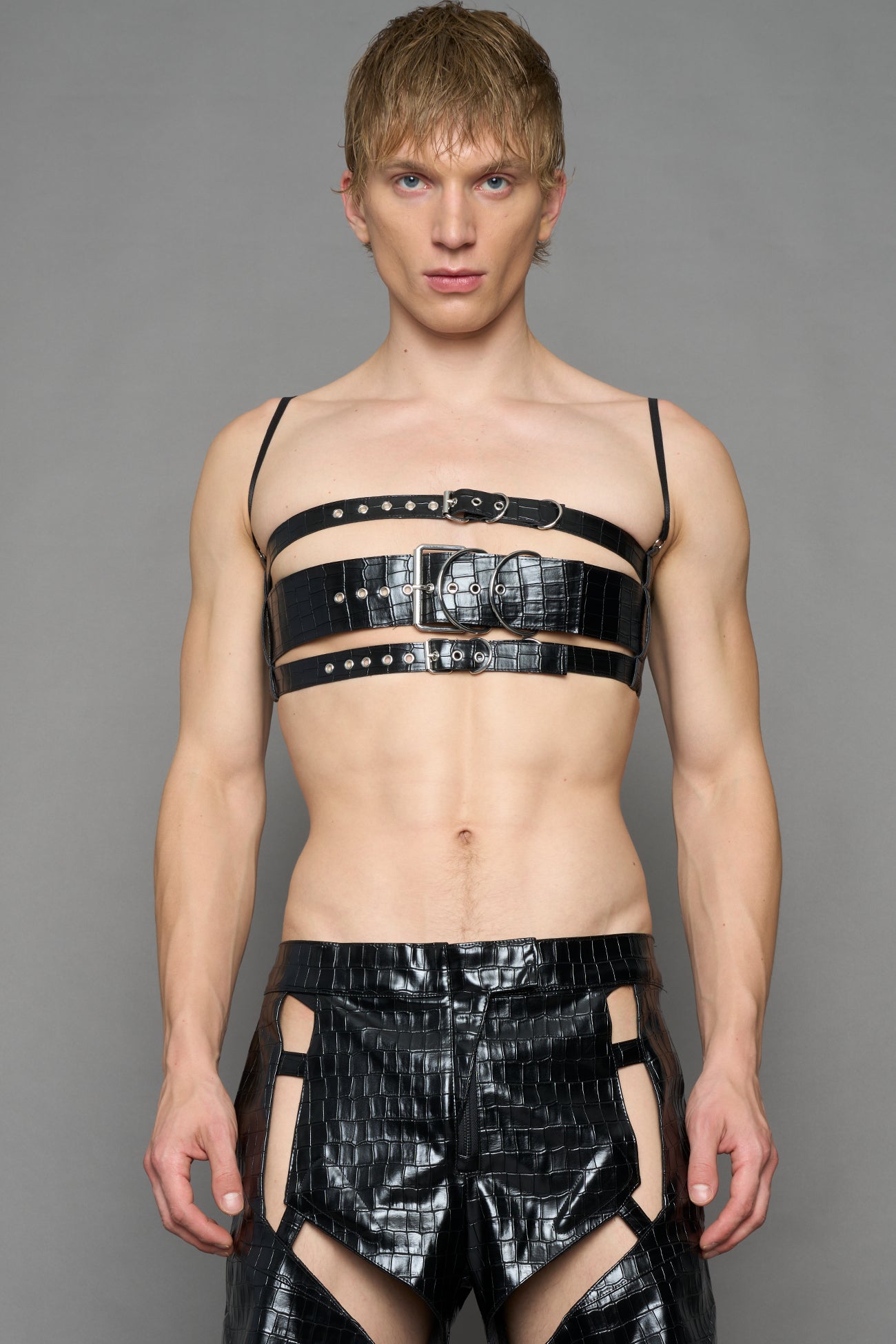 model wearing black vegan leather croc inspired belt top with buckle details