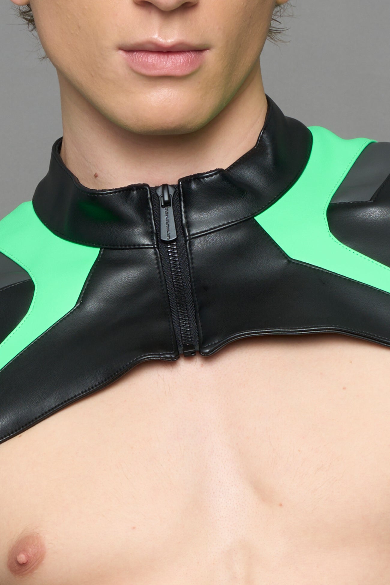model wearing black white and green cropped jacket with logo on the arm