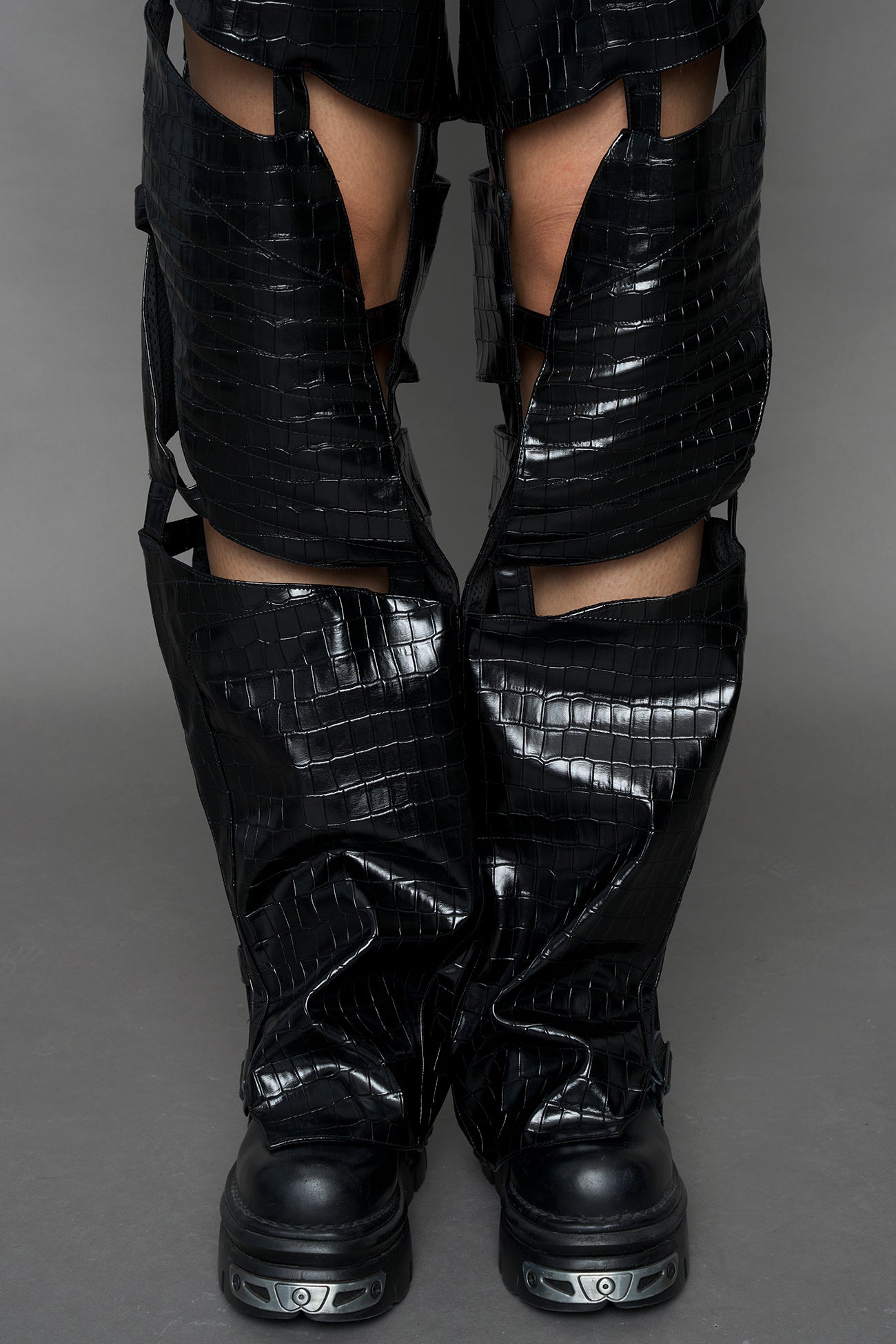 model wearing black croc vegan leather pants with cut out details
