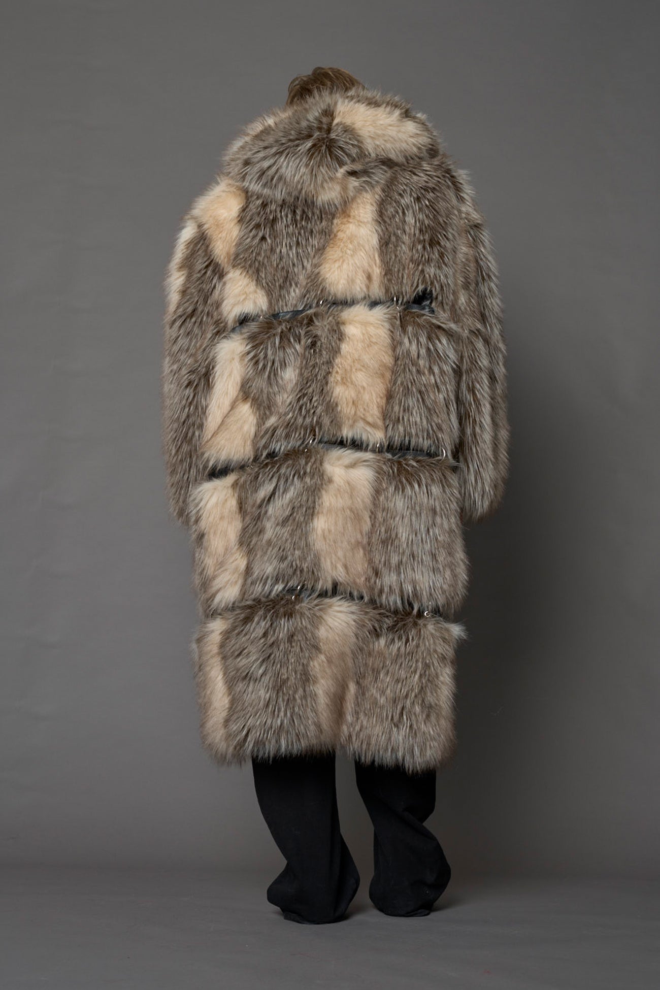 model wearing brown faux fur coat with silver metal rings