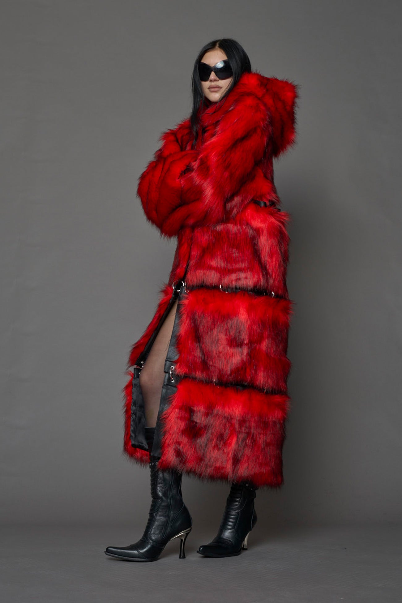 model wearing red faux fur coat with silver metal rings