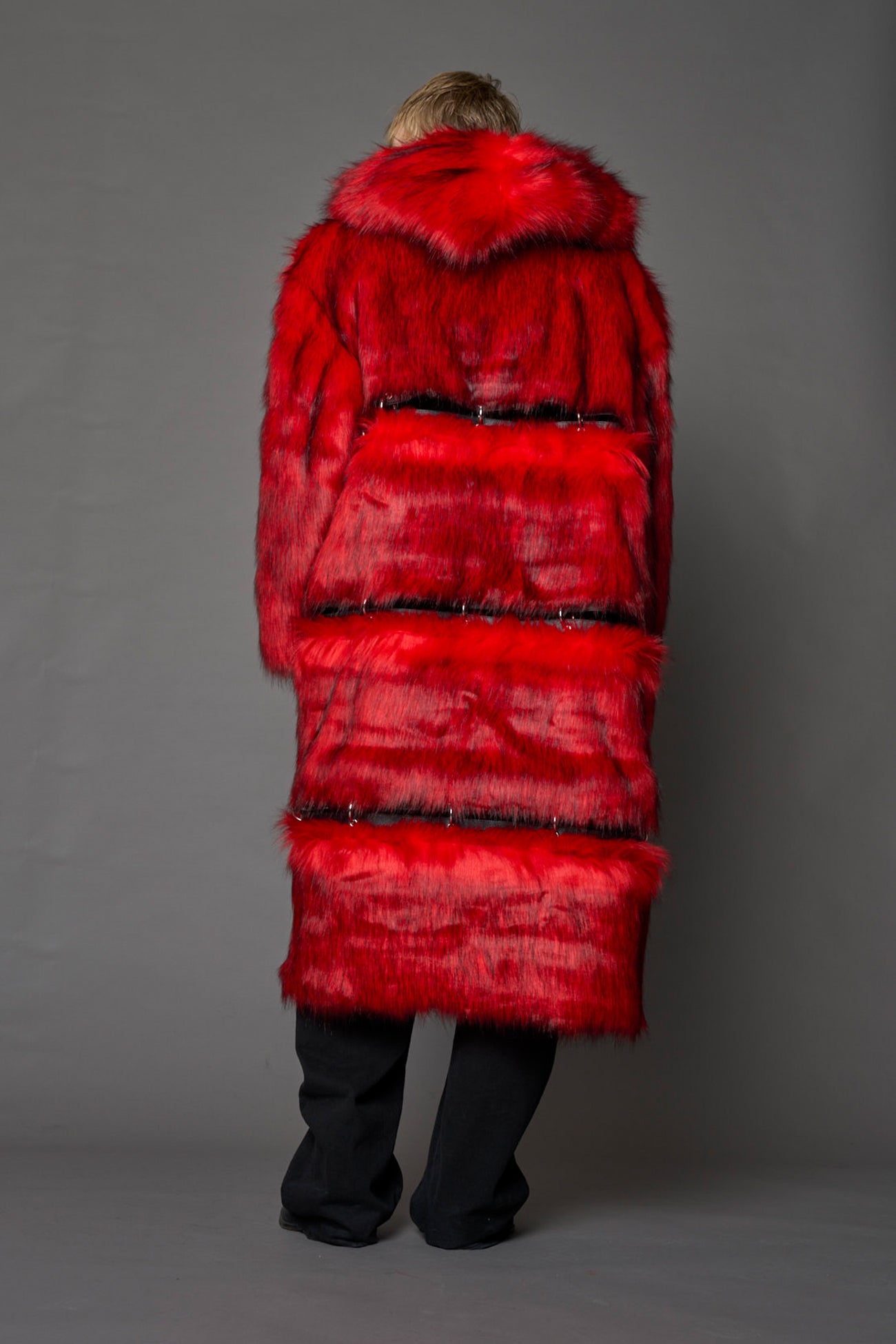 model wearing red faux fur coat with silver metal rings