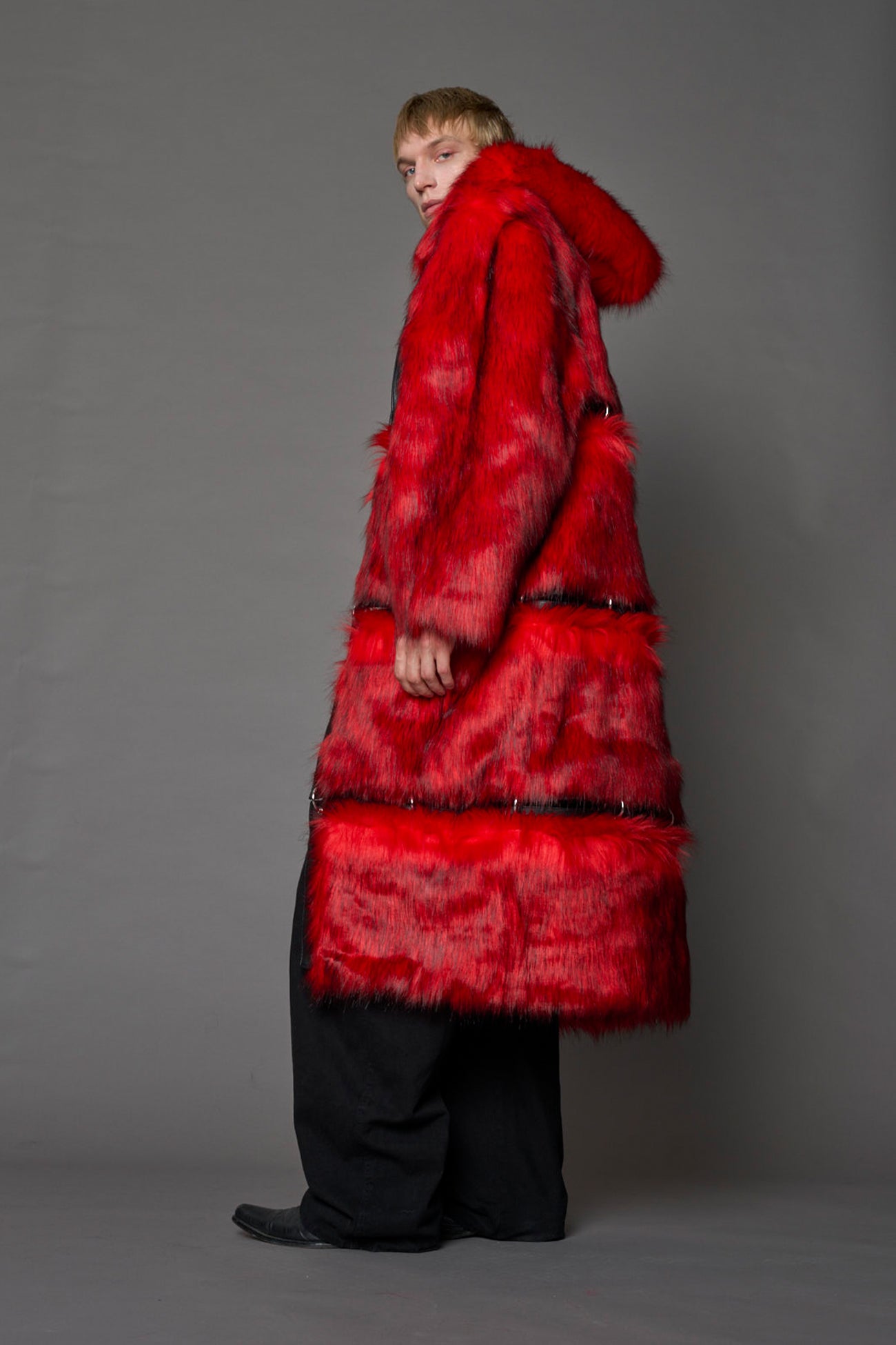 model wearing red faux fur coat with silver metal rings