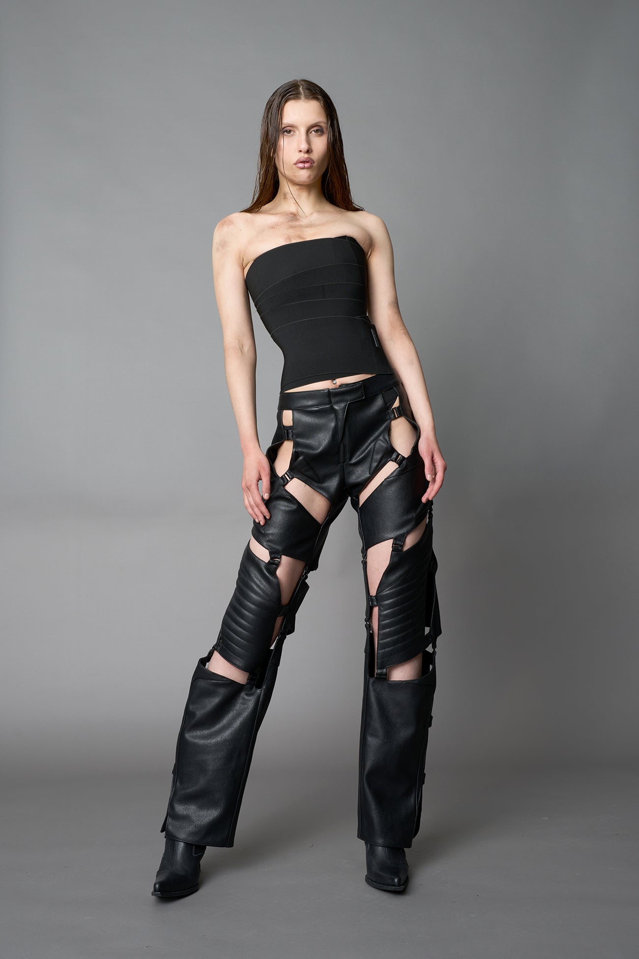 Model wearing black strapless bandage crop top with structured compression fit, edgy Y2K streetwear outfit by Namilia.