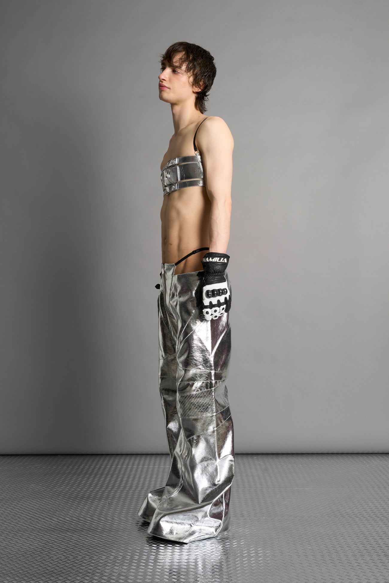 silver vegan leather belt top with three adjustable grommet straps, oversized metal buckles, and circular hardware – edgy bondage-inspired crop top for festival or clubwear.
