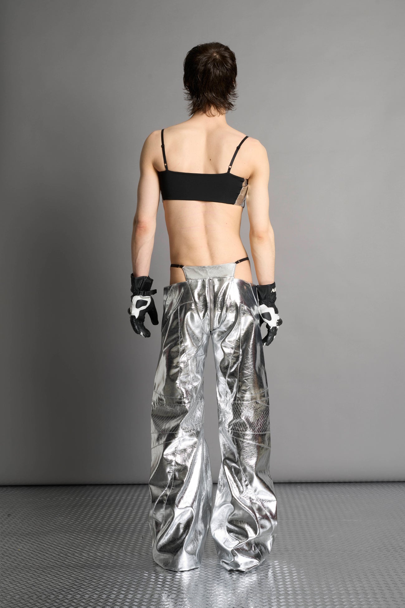 silver vegan leather belt top with three adjustable grommet straps, oversized metal buckles, and circular hardware – edgy bondage-inspired crop top for festival or clubwear.