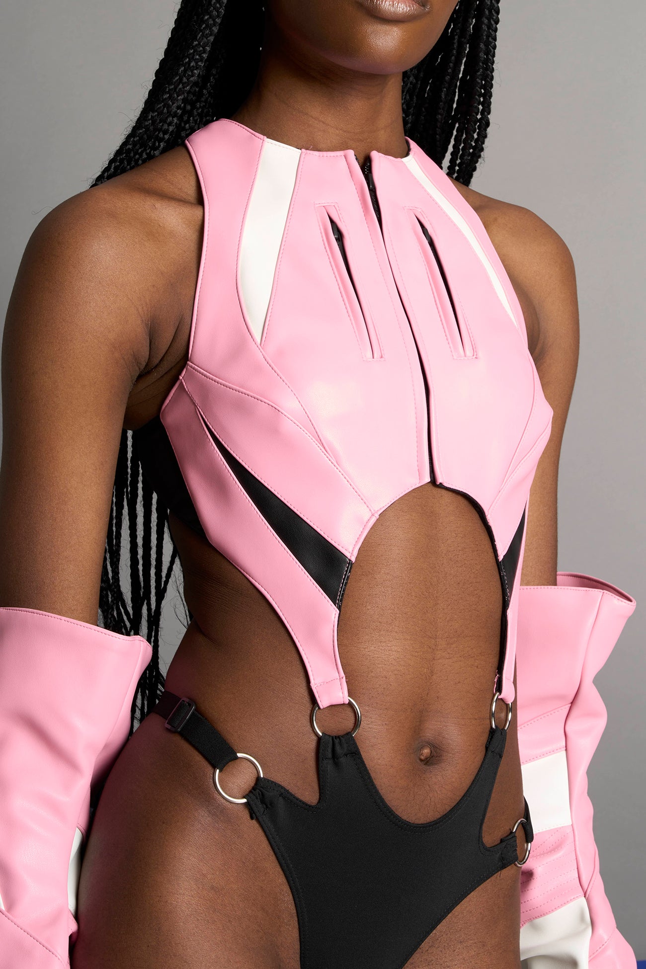 model wearing pink cut out motocross body with string elastic panty part