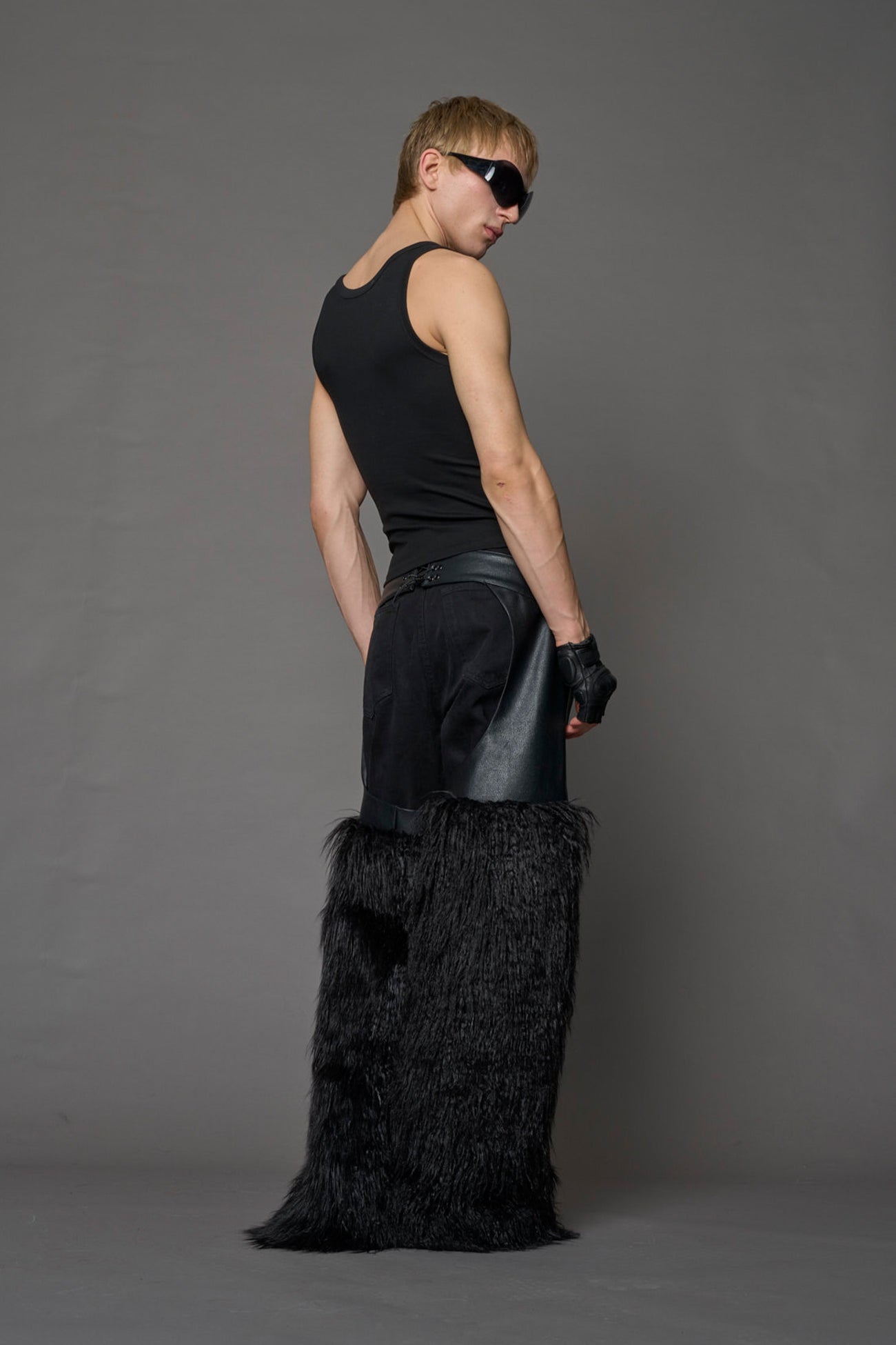 model wearing black vegan leather and faux fur chaps