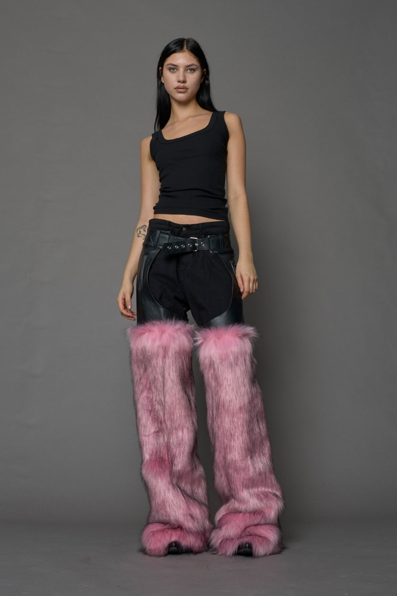 model wearing pink vegan leather and faux fur chaps
