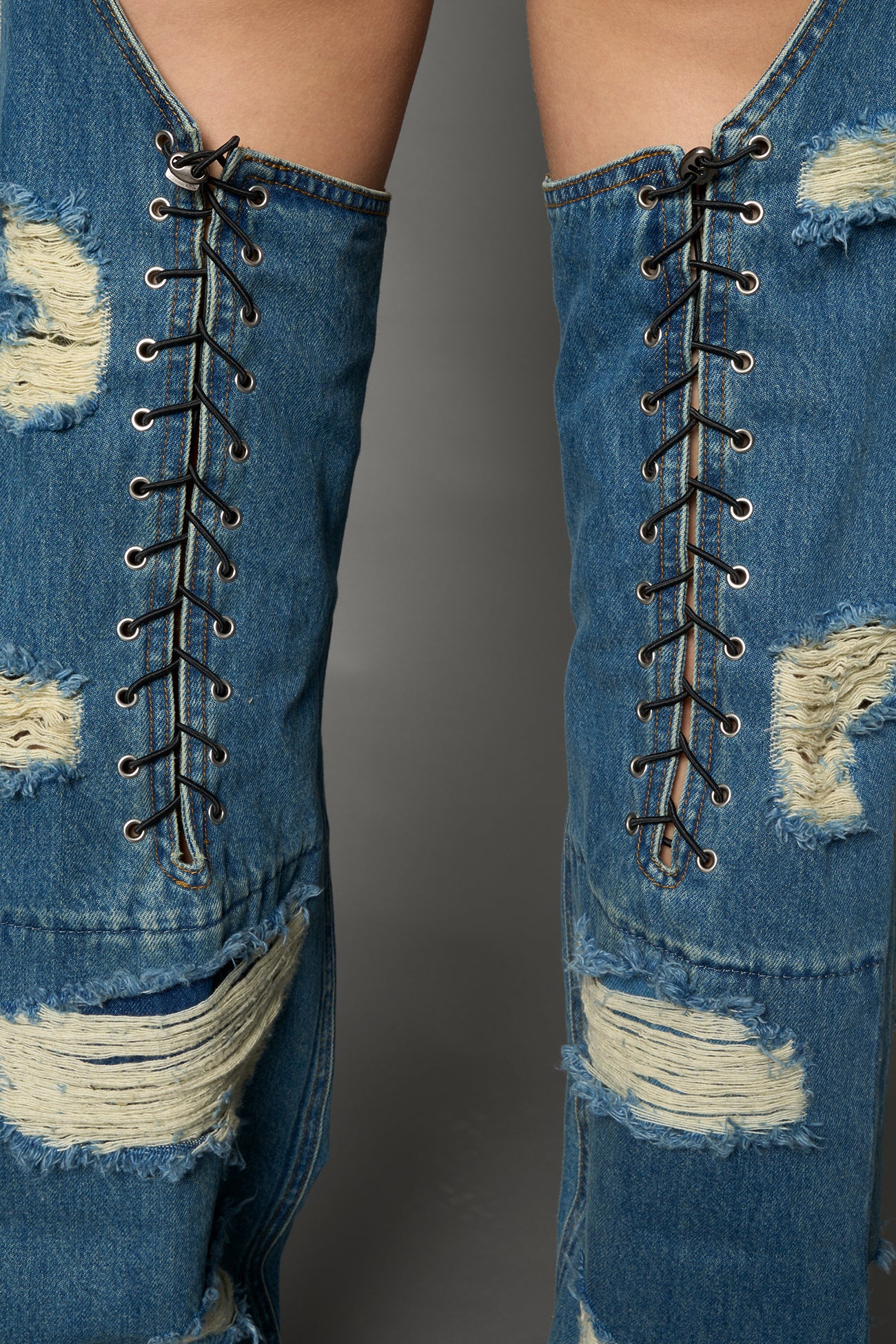 Namilia shredded blue denim chaps with low-rise fit, extreme thigh cut-outs and distressed straight legs