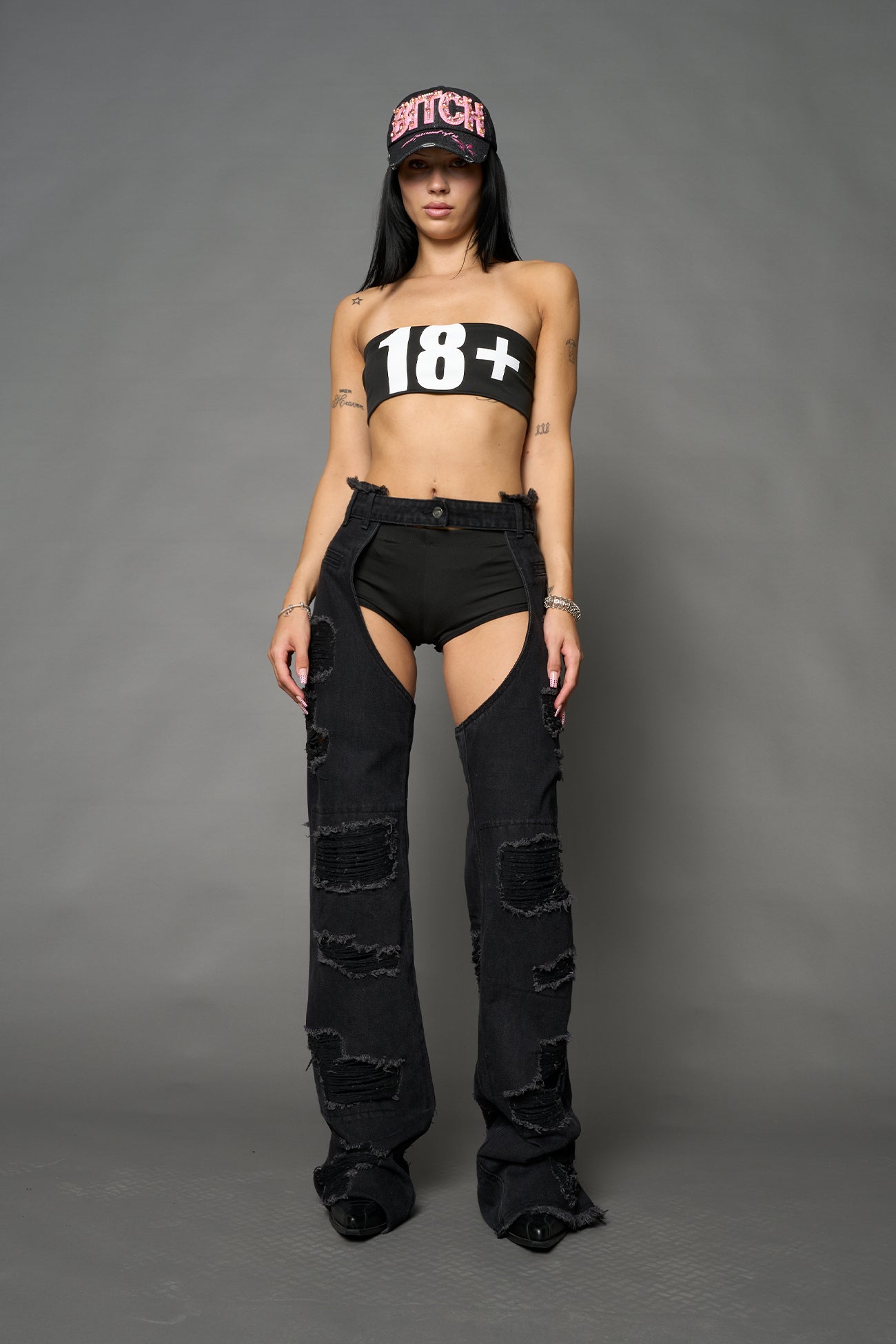 Namilia shredded black denim chaps with low-rise fit, extreme thigh cut-outs and distressed straight legs