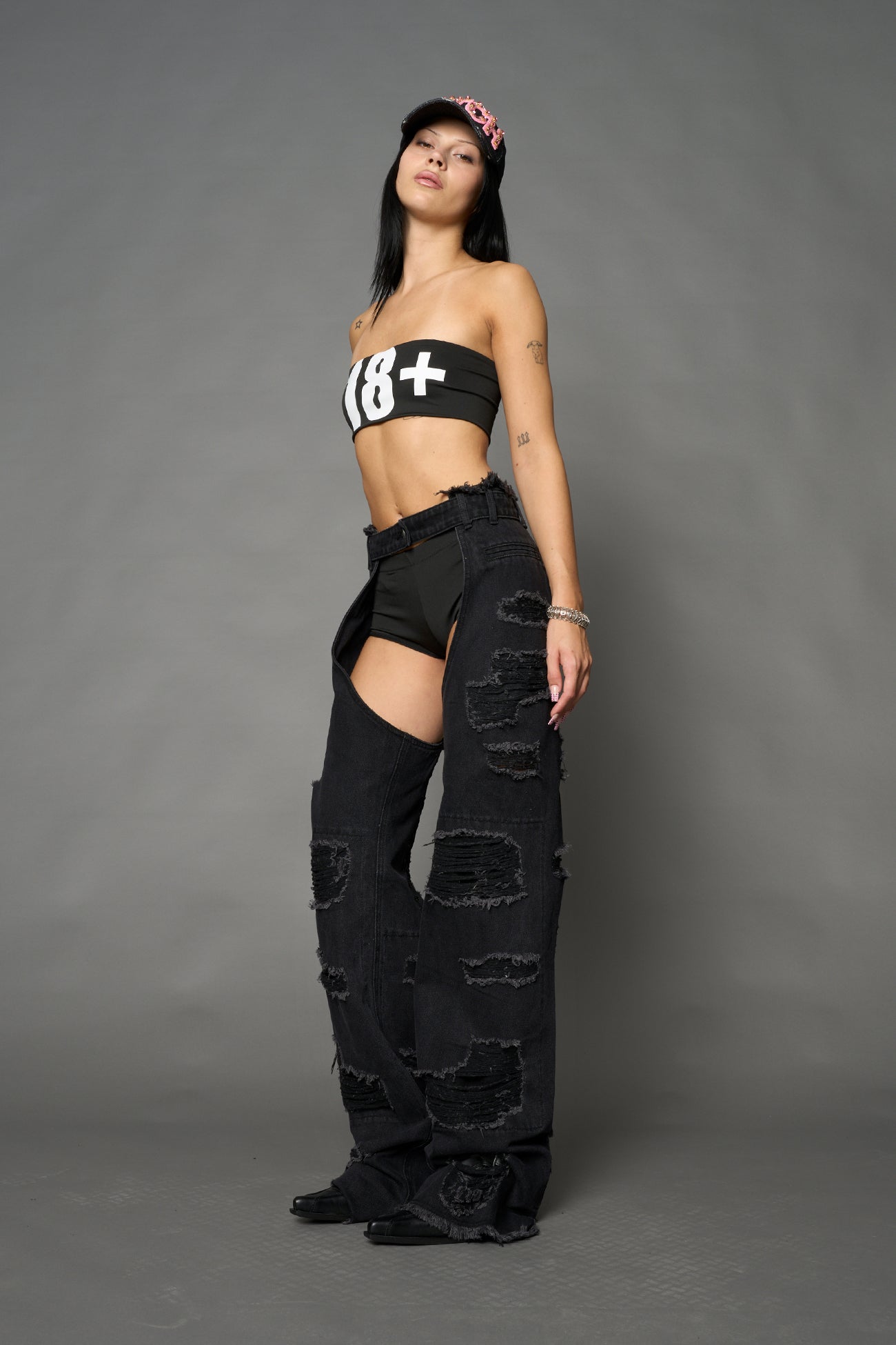 Namilia shredded black denim chaps with low-rise fit, extreme thigh cut-outs and distressed straight legs