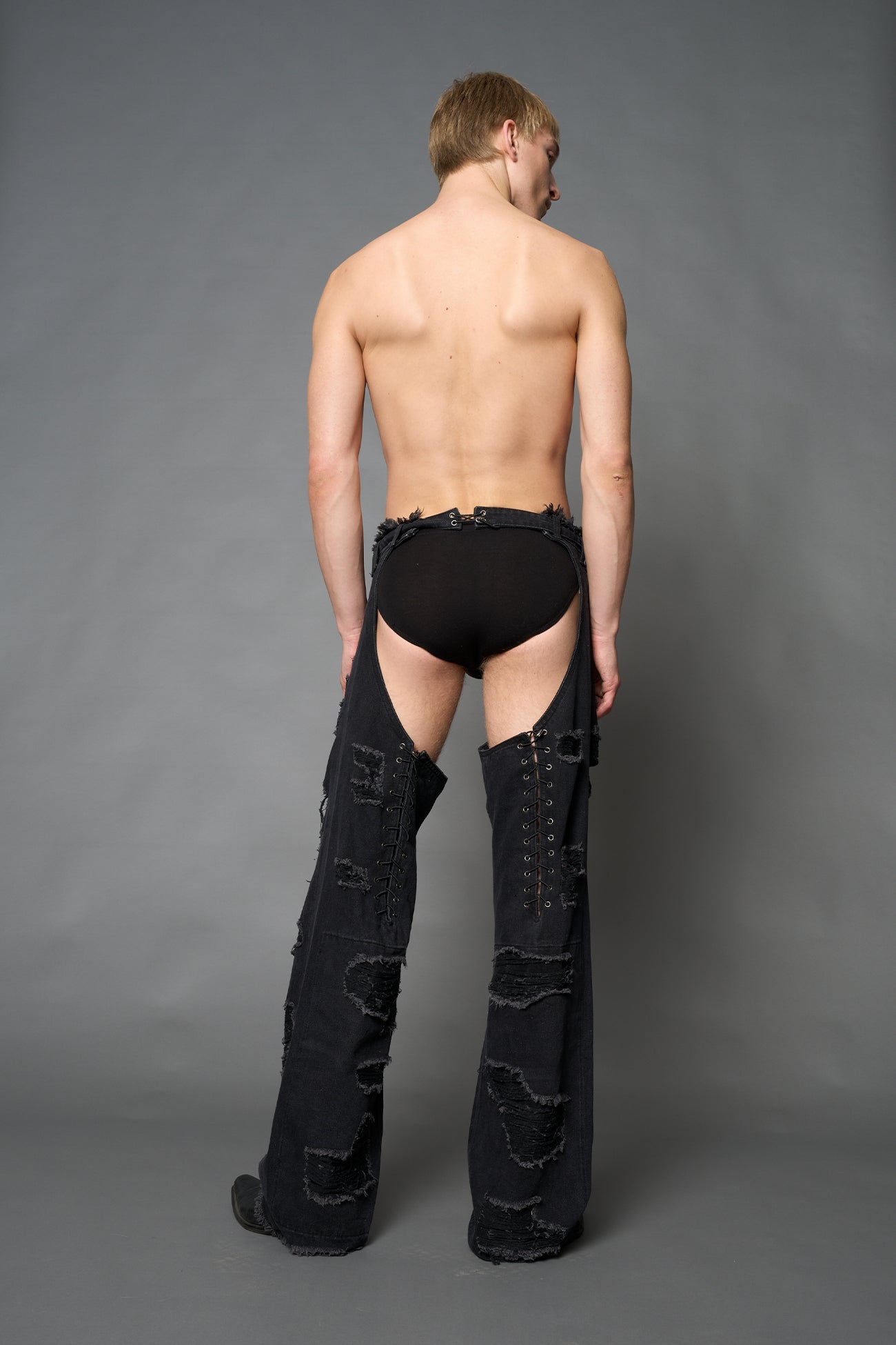Namilia shredded black denim chaps with low-rise fit, extreme thigh cut-outs and distressed straight legs