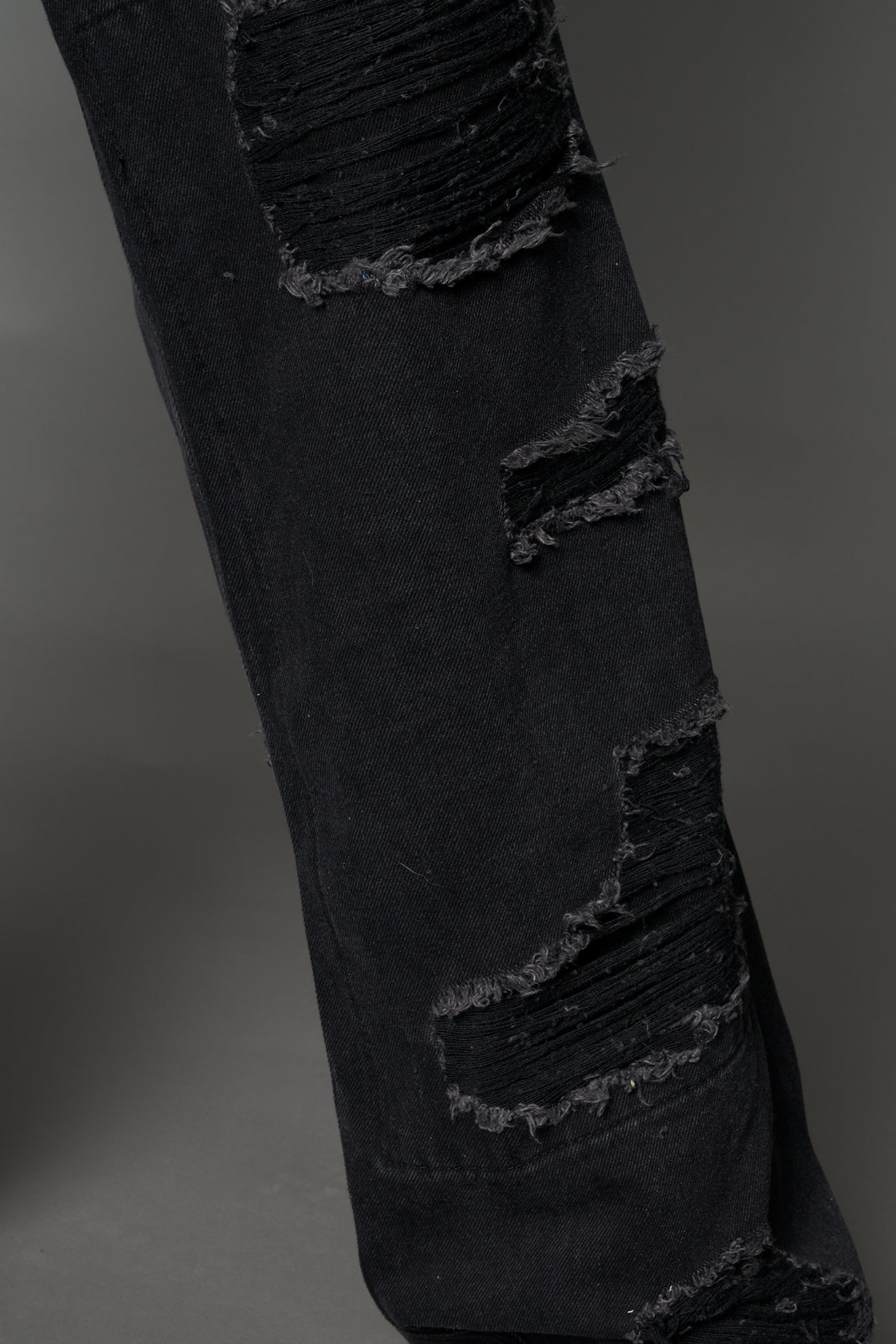 Namilia shredded black denim chaps with low-rise fit, extreme thigh cut-outs and distressed straight legs