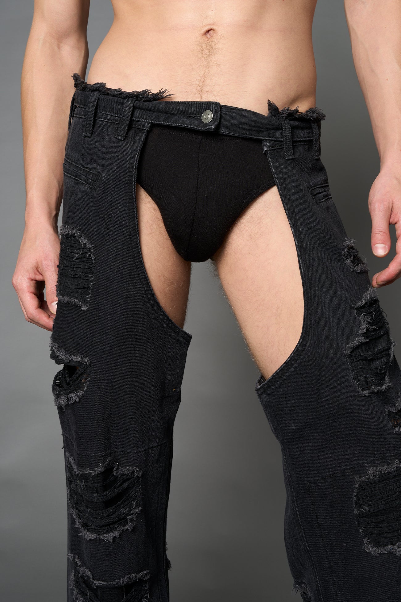 Namilia shredded black denim chaps with low-rise fit, extreme thigh cut-outs and distressed straight legs