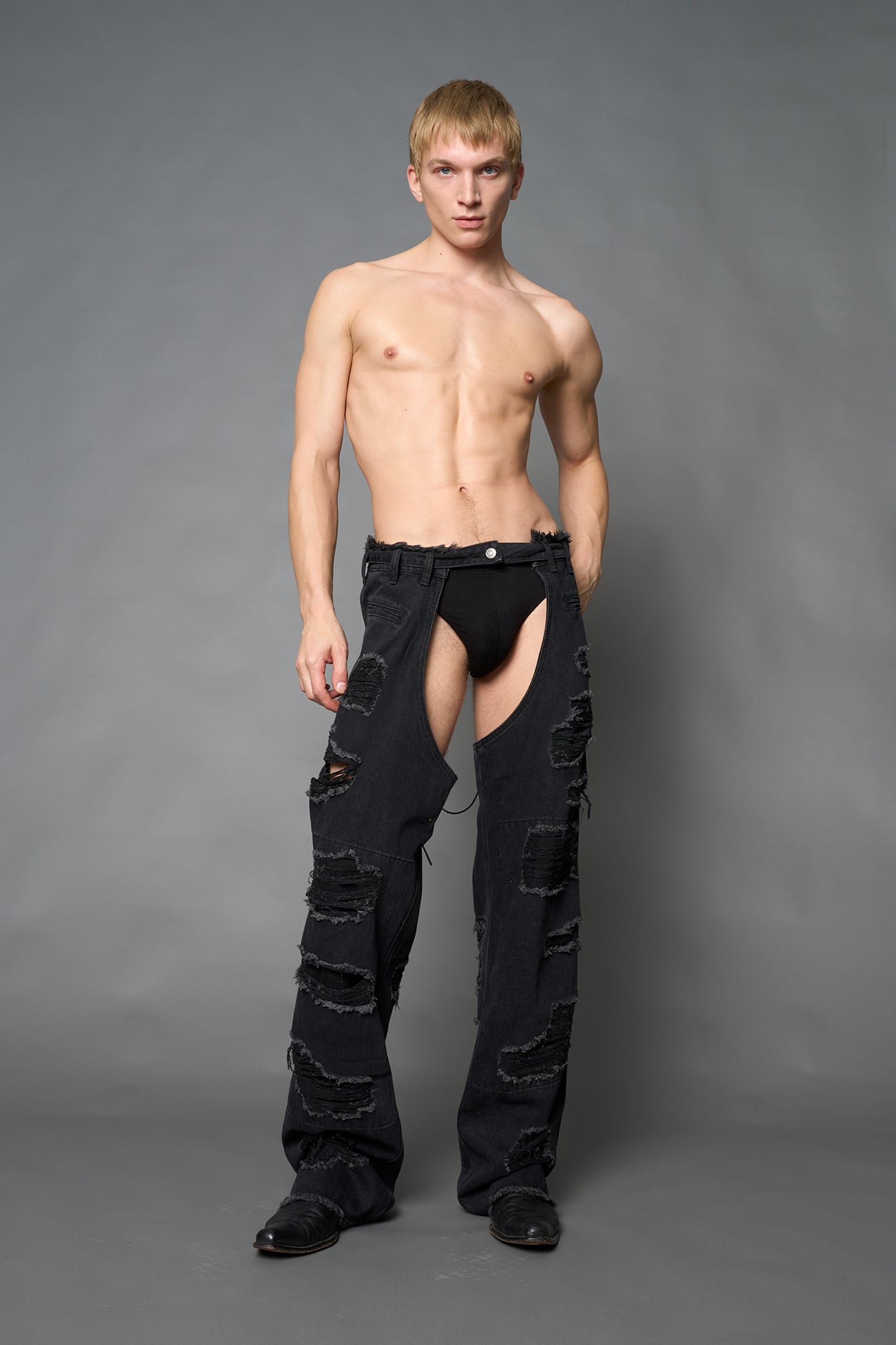 Namilia shredded black denim chaps with low-rise fit, extreme thigh cut-outs and distressed straight legs