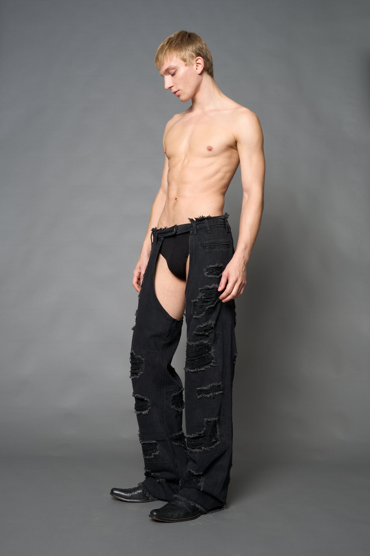 Namilia shredded black denim chaps with low-rise fit, extreme thigh cut-outs and distressed straight legs