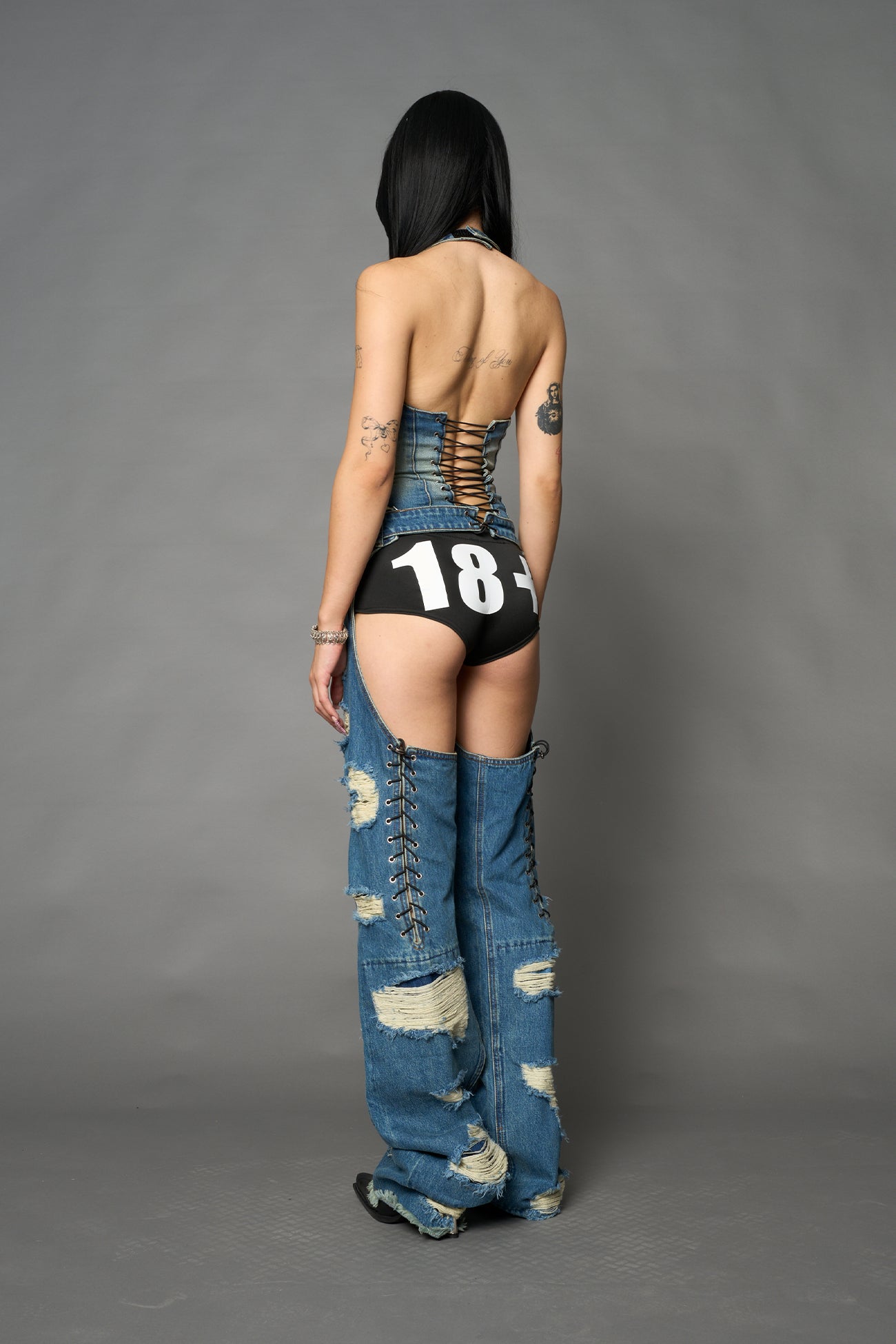 Namilia shredded blue denim chaps with low-rise fit, extreme thigh cut-outs and distressed straight legs