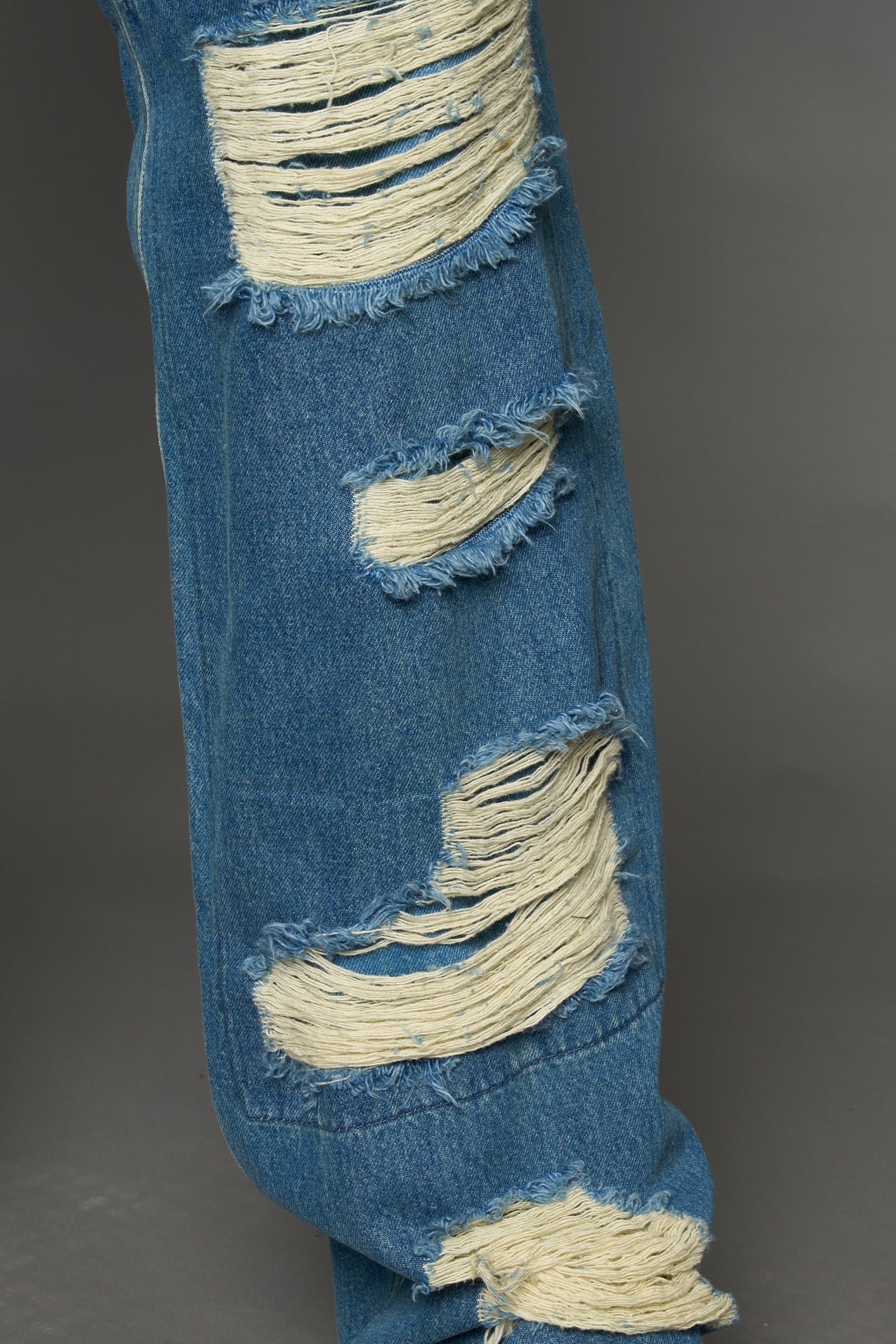 Namilia shredded blue denim chaps with low-rise fit, extreme thigh cut-outs and distressed straight legs