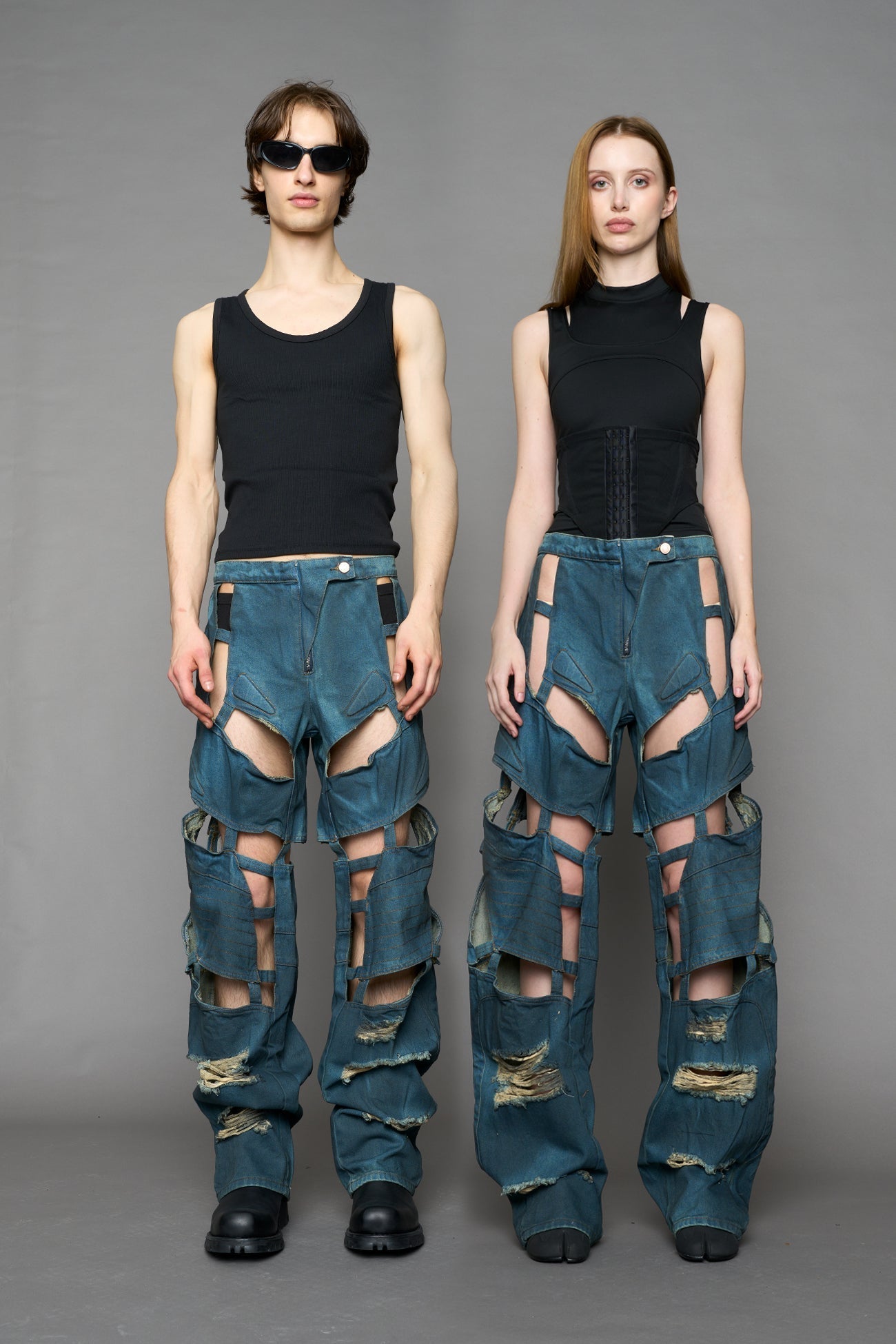 model wearing blue smoke denim pants with motocross inspired cut outs BLUE SMOKE
