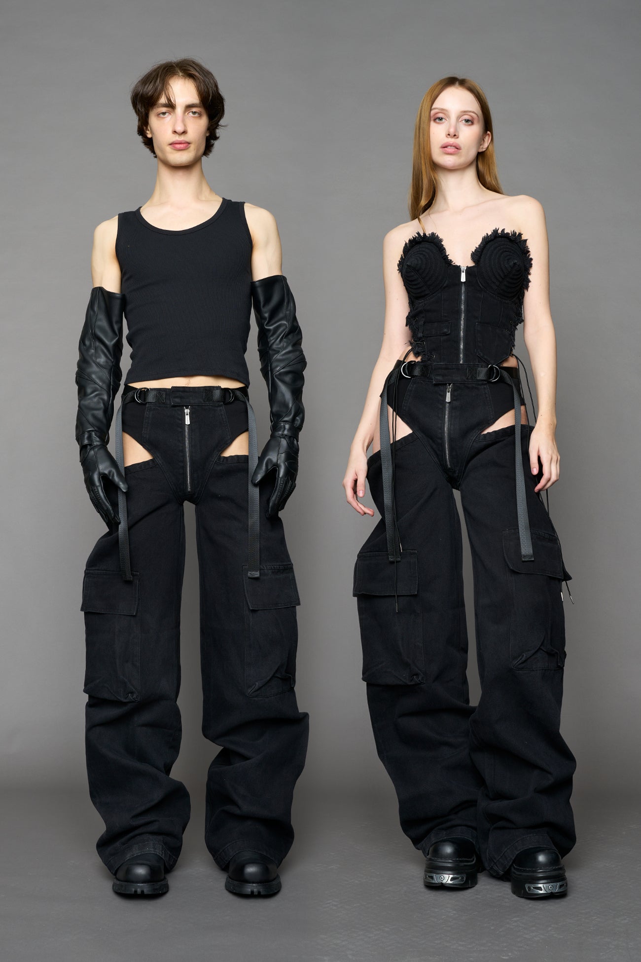 model wearing black dark washed denim trousers with cut out design and 3D pockets