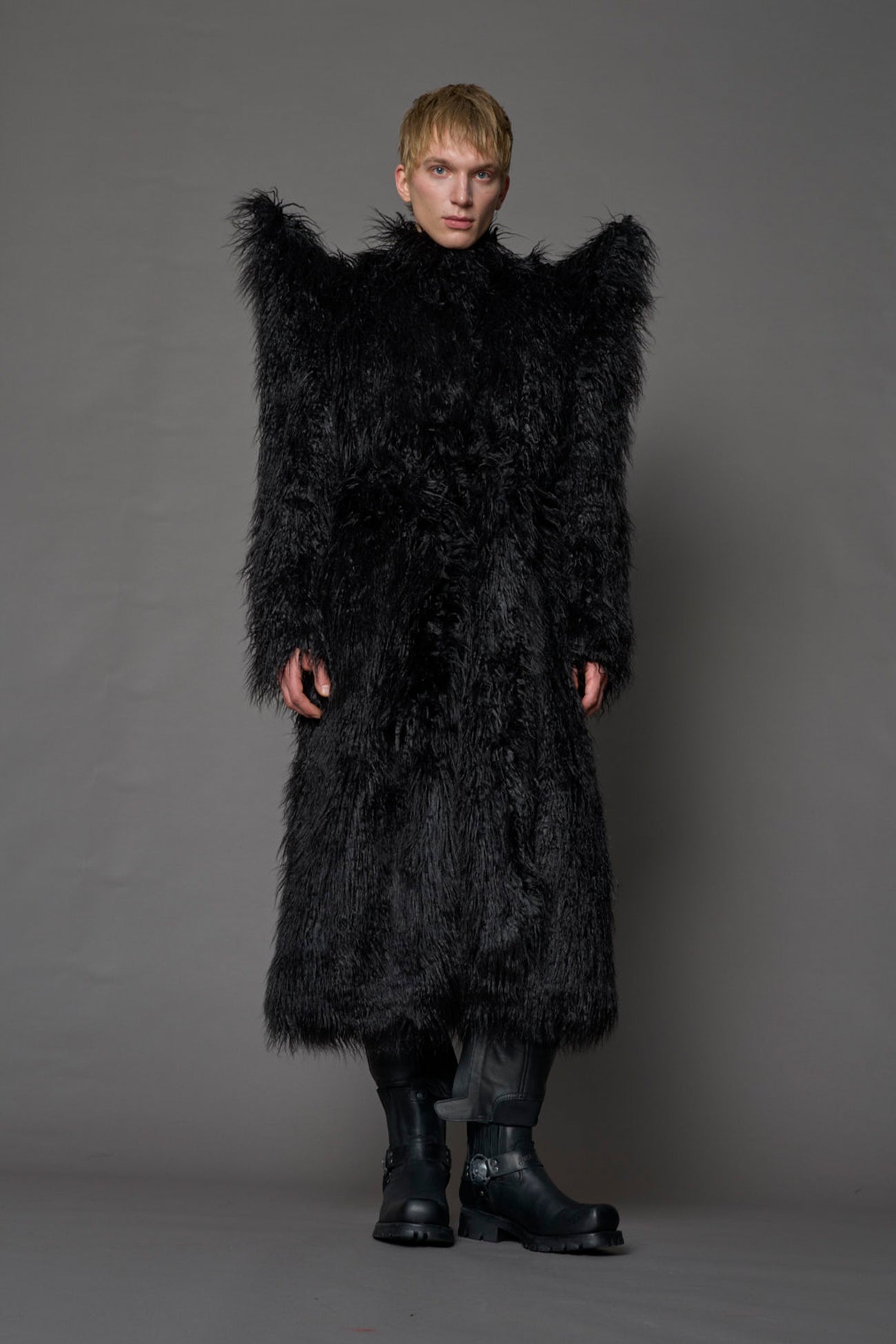 model wearing black spike shoulder long faux fur coat
