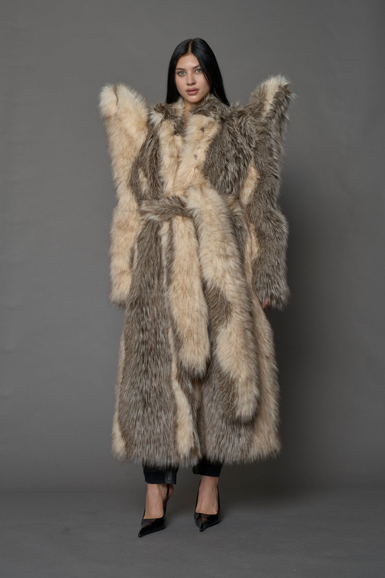 model wearing brown spike shoulder long faux fur coat