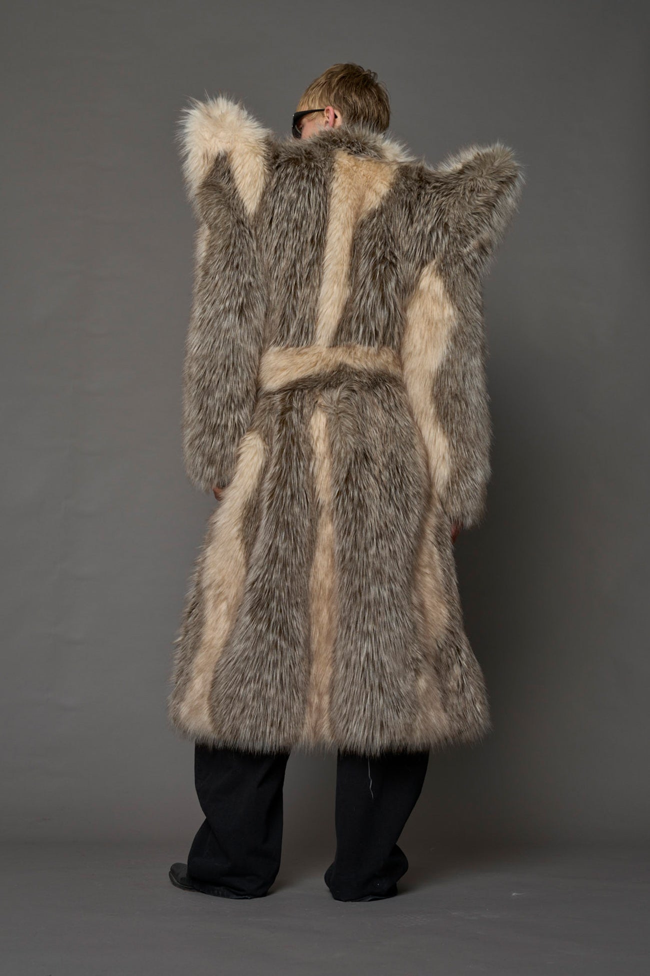 model wearing brown spike shoulder long faux fur coat